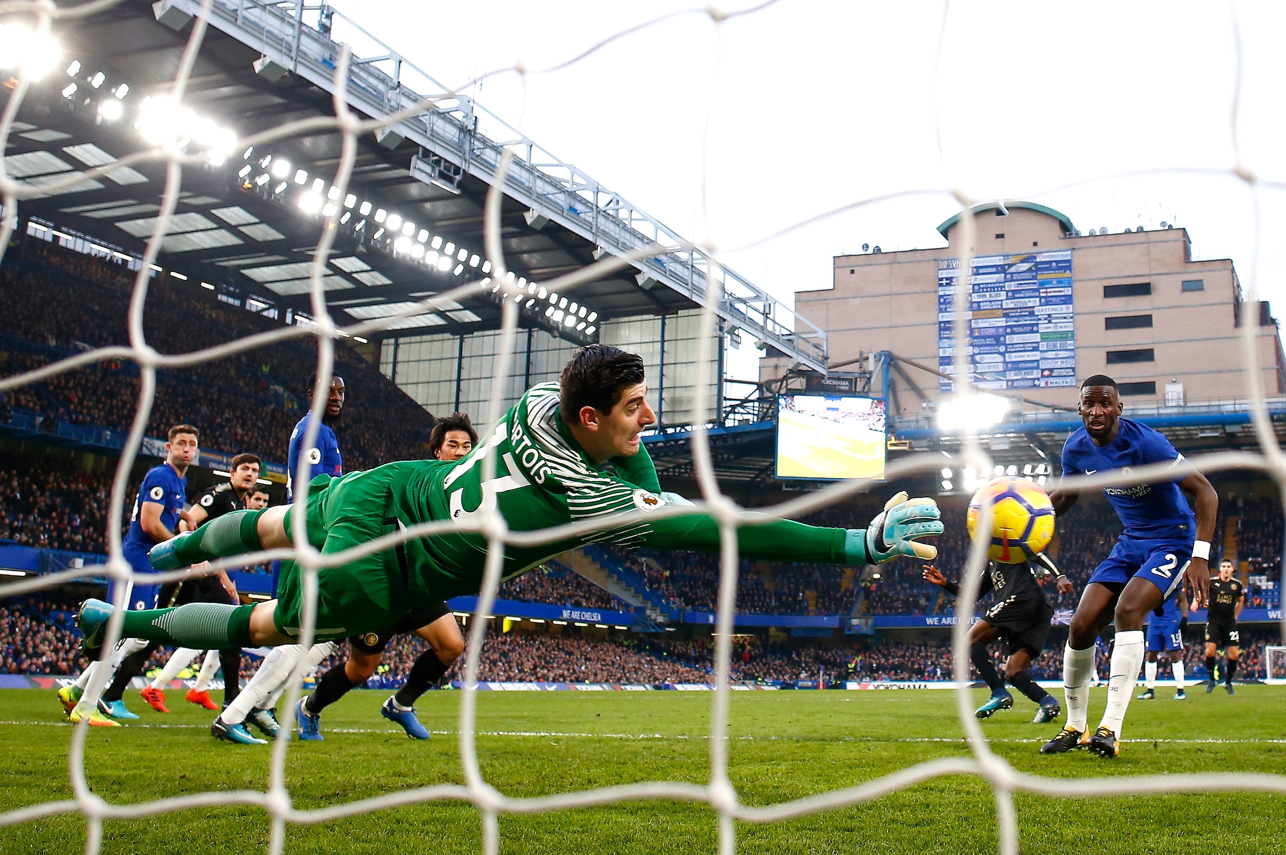 LONDON, ENGLAND - JANUARY 13: Thibaut Courtois of Chelsea dives to make a save during the Premier League match between Chelsea and Leicester City at Stamford Bridge on January 13, 2018 in London, England.  (Photo by Clive Rose/Getty Images)
