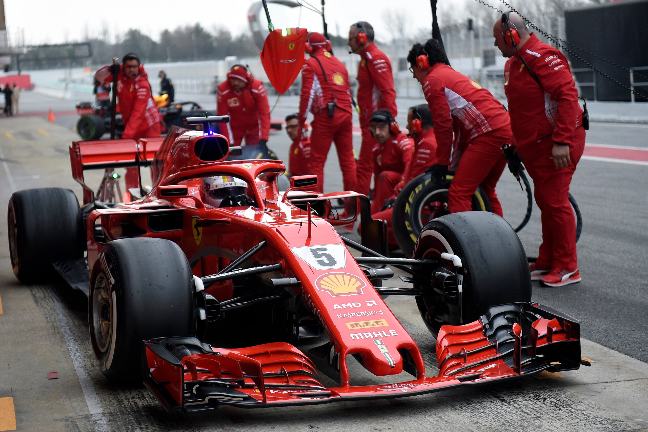 Ferrari's German driver Sebastian Vettel arrives in the pits at the Circuit de Catalunya on February 27, 2018 in Montmelo on the outskirts of Barcelona during the second day of the first week of tests for the Formula One Grand Prix season.  / AFP PHOTO / 