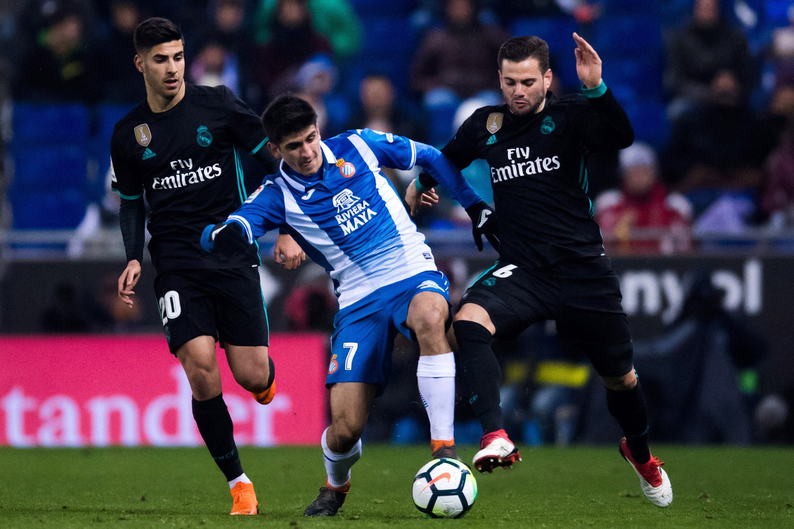 BARCELONA, SPAIN - FEBRUARY 27: Gerard Moreno (C) of RCD Espanyol competes for the ball with Marco Asensio (L) and Nacho Fernandez (R) of Real Madrid CF during the La Liga match between Espanyol and Real Madrid at RCDE Stadium on February 27, 2018 in Barc BARCELONA, SPAIN - FEBRUARY 27: Gerard Moreno (C) of RCD Espanyol competes for the ball with Marco Asensio (L) and Nacho Fernandez (R) of Real Madrid CF during the La Liga match between Espanyol and Real Madrid at RCDE Stadium on February 27, 2018 in Barc