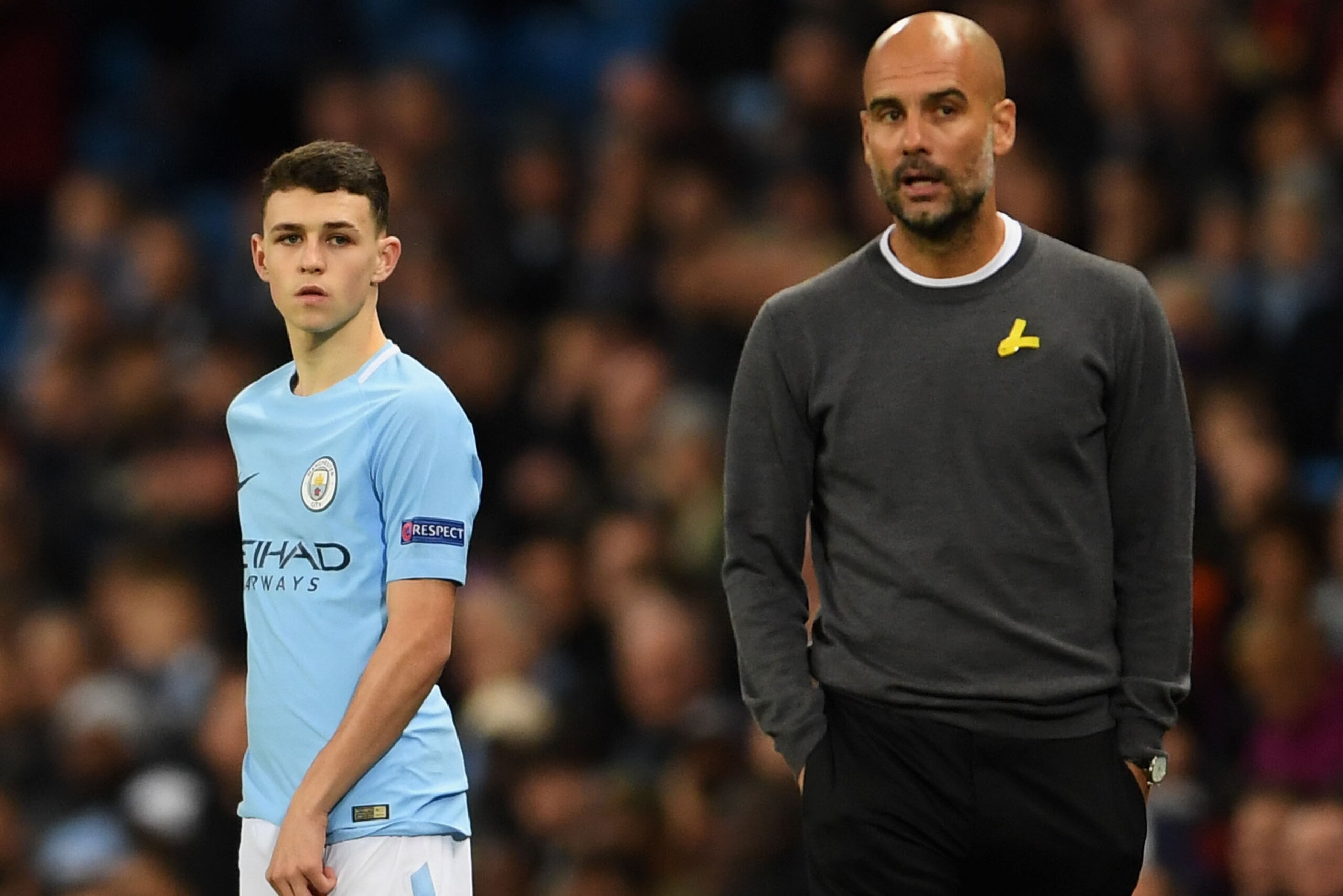 MANCHESTER, ENGLAND - NOVEMBER 21: Phil Foden of Manchester City and Josep Guardiola, Manager of Manchester City looks on during the UEFA Champions League group F match between Manchester City and Feyenoord at Etihad Stadium on November 21, 2017 in Manche