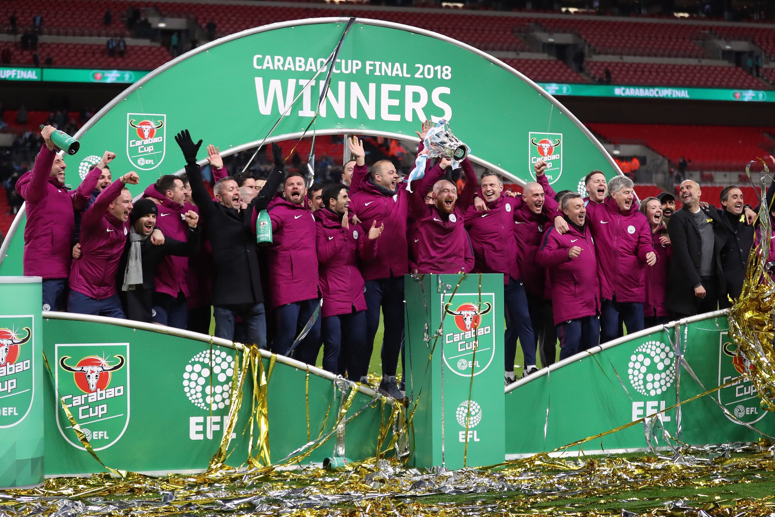 LONDON, ENGLAND - FEBRUARY 25: Pep Guardiola manager / head coach of Manchester City celebrates with his coaching staff after winning the Carabao Cup after the Carabao Cup Final match between Arsenal and Manchester City at Wembley Stadium on February 25, LONDON, ENGLAND - FEBRUARY 25: Pep Guardiola manager / head coach of Manchester City celebrates with his coaching staff after winning the Carabao Cup after the Carabao Cup Final match between Arsenal and Manchester City at Wembley Stadium on February 25,
