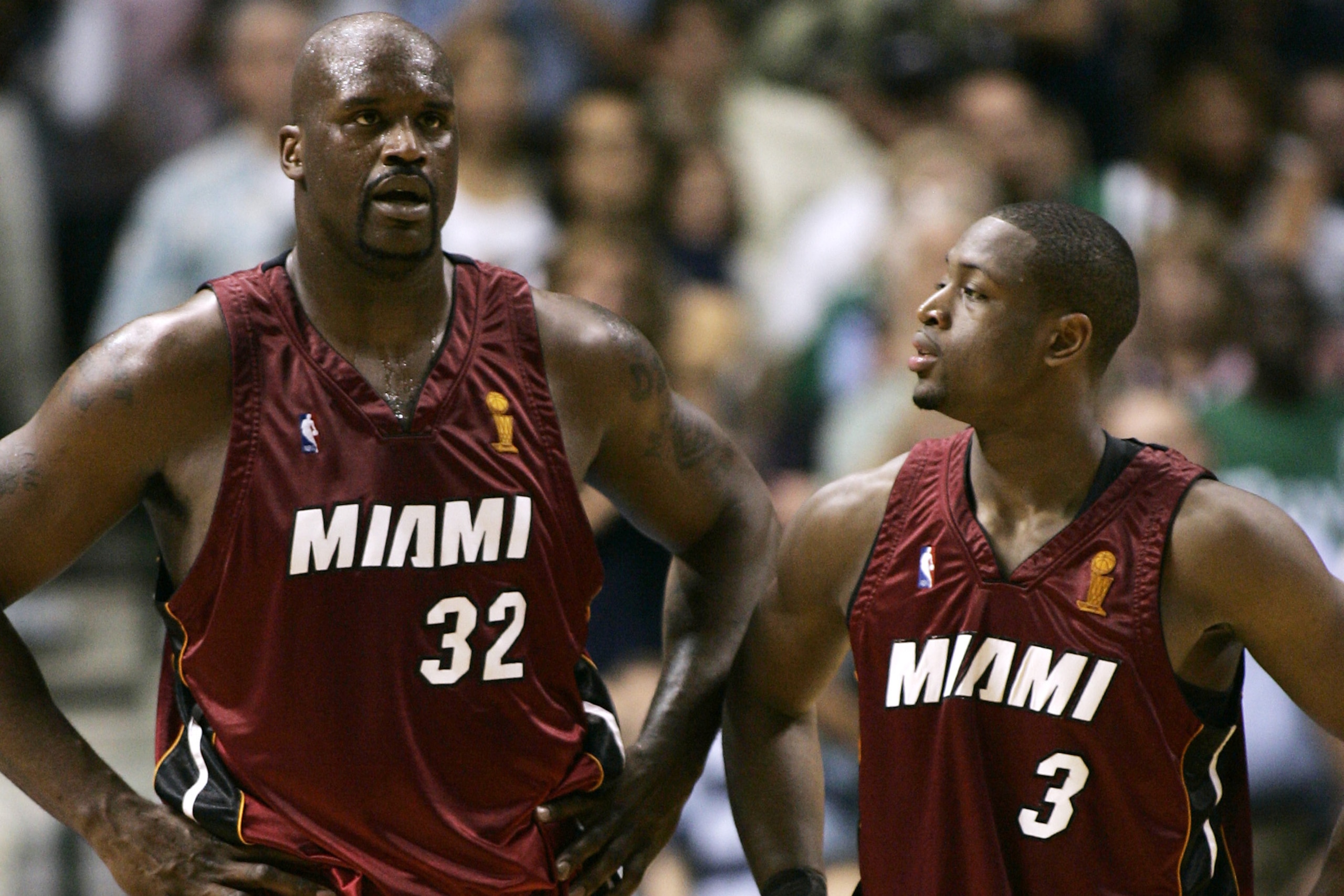 Shaquille O'Neal (L) of the Miami Heat talks with teammate Dwyane Wade (R) during Game Six of the NBA Finals against the Dallas Mavericks 20 June 2006 at the American Airlines Center in Dallas, Texas.  The Miami Heat lead the best-of-seven game series 3-2