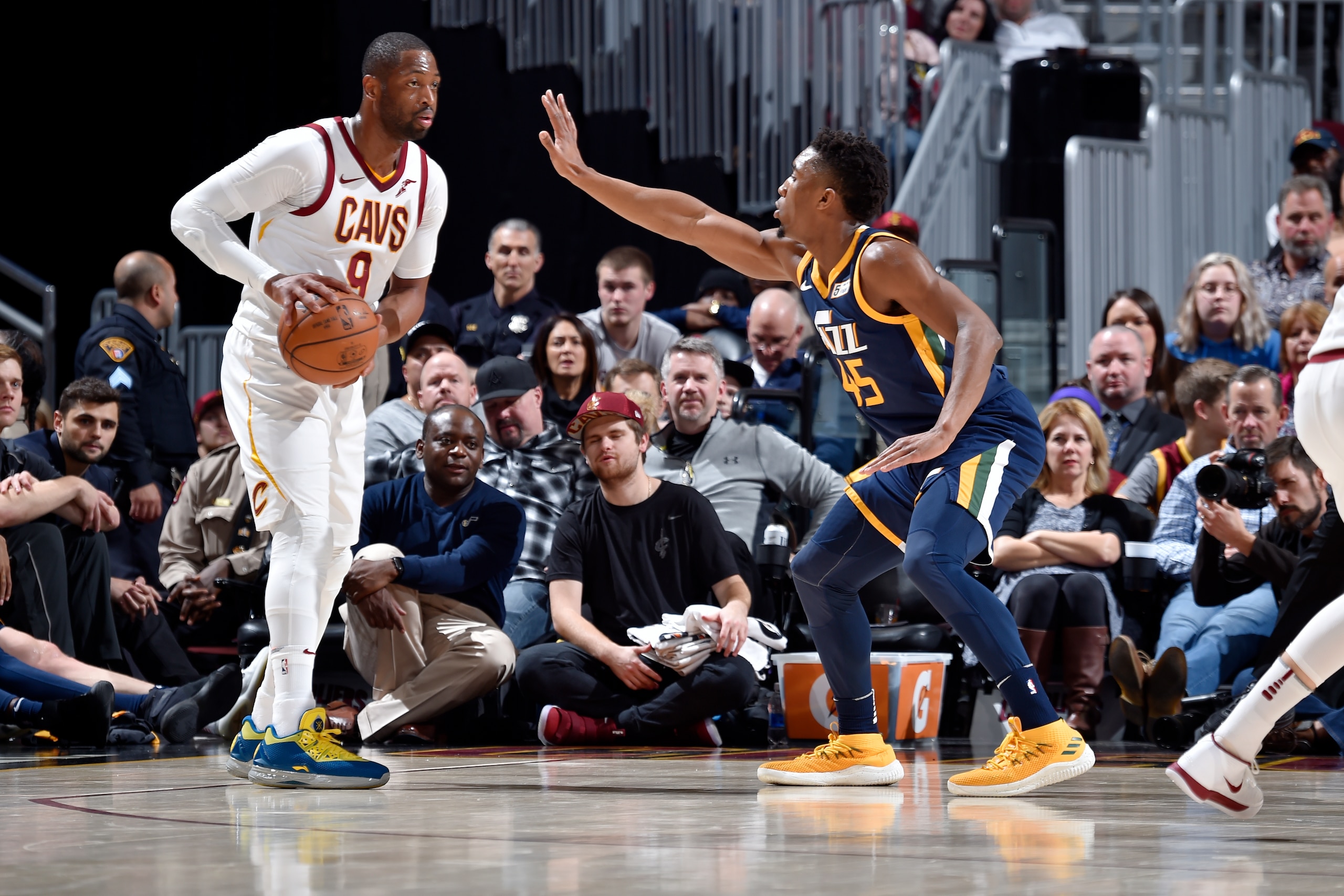CLEVELAND, OH - DECEMBER 16: Dwyane Wade #9 of the Cleveland Cavaliers handles the ball against Donovan Mitchell #45 of the Utah Jazz during the game between the two teams  on December 16. 2017 at Quicken Loans Arena in Cleveland, Ohio. NOTE TO USER: User
