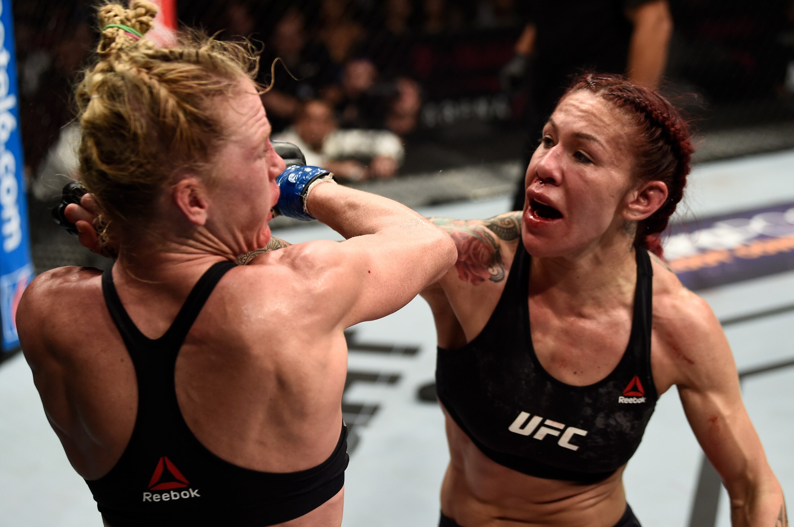 LAS VEGAS, NV - DECEMBER 30:  (R-L) Cris Cyborg of Brazil punches Holly Holm in their women's featherweight bout during the UFC 219 event inside T-Mobile Arena on December 30, 2017 in Las Vegas, Nevada. (Photo by Jeff Bottari/Zuffa LLC/Zuffa LLC via Getty