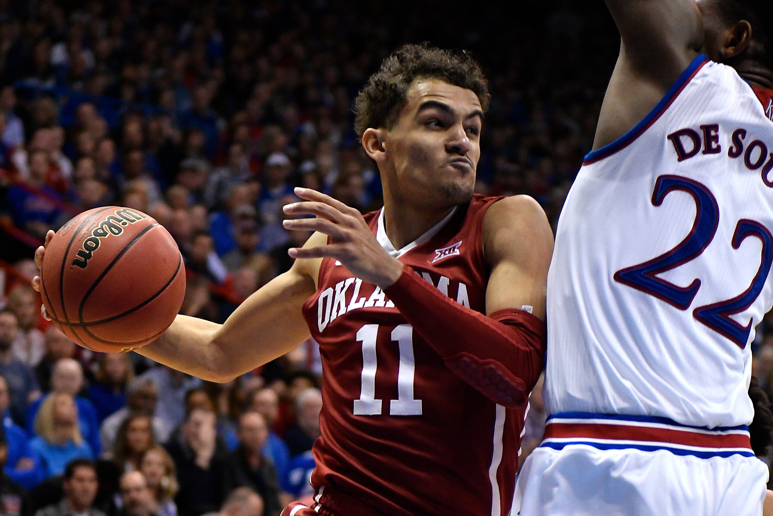 LAWRENCE, KS - FEBRUARY 19: Trae Young #11 of the Oklahoma Sooners looks to pass the ball against Silvio De Sousa #22 of the Kansas Jayhawks in the second half at Allen Fieldhouse on February 19, 2018 in Lawrence, Kansas. (Photo by Ed Zurga/Getty Images)