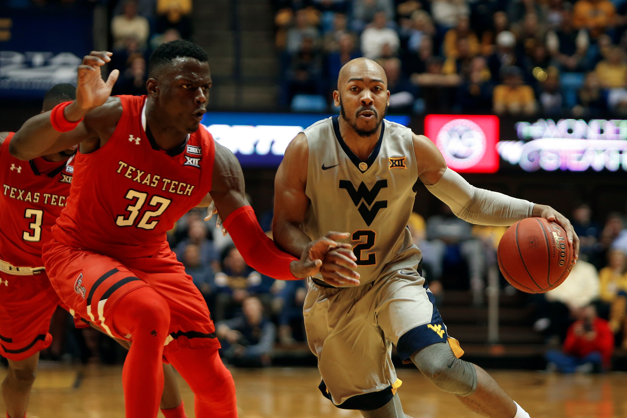 MORGANTOWN, WV - FEBRUARY 26:  Jevon Carter #2 of the West Virginia Mountaineers brings the ball down court against Norense Odiase #32 of the Texas Tech Red Raiders at the WVU Coliseum on February 26, 2018 in Morgantown, West Virginia.  (Photo by Justin K