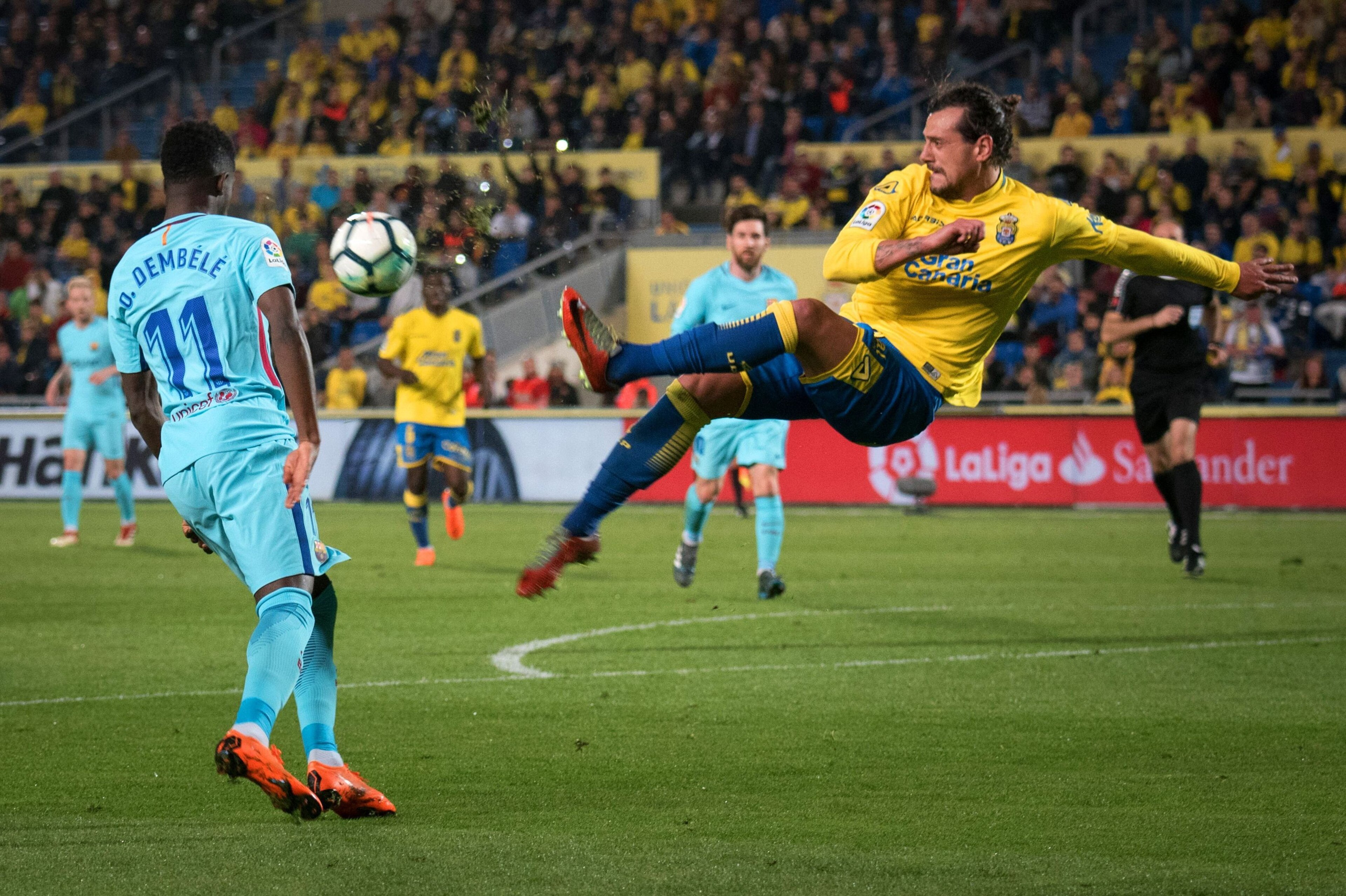 Las Palmas' Uruguayan defender Matias Aguirregaray (R) vies with Barcelona's French midfielder Ousmane Dembele (L) during the Spanish league football match UD Las Palmas vs FC Barcelona at the Gran Canaria stadium in Las Palmas de Gran Canaria on March 01