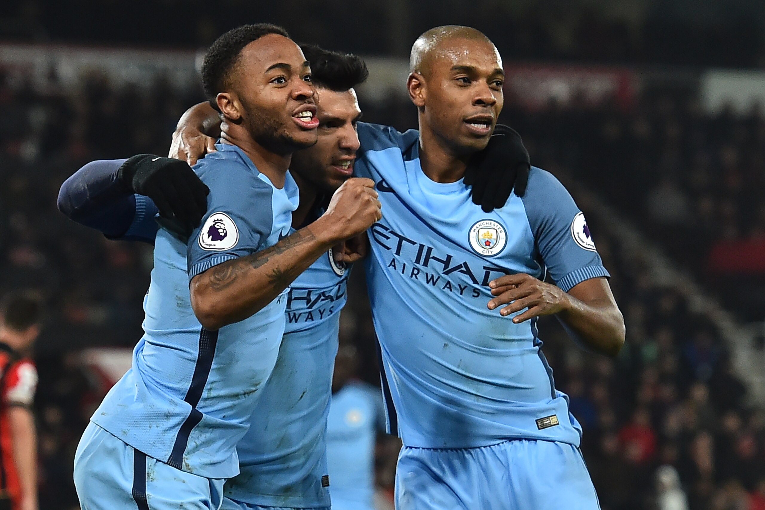 Manchester City's Argentinian striker Sergio Aguero (C) celebrates with Manchester City's English midfielder Raheem Sterling and Manchester City's Brazilian midfielder Fernandinho (R) after scoring their second goal during the English Premier League footb