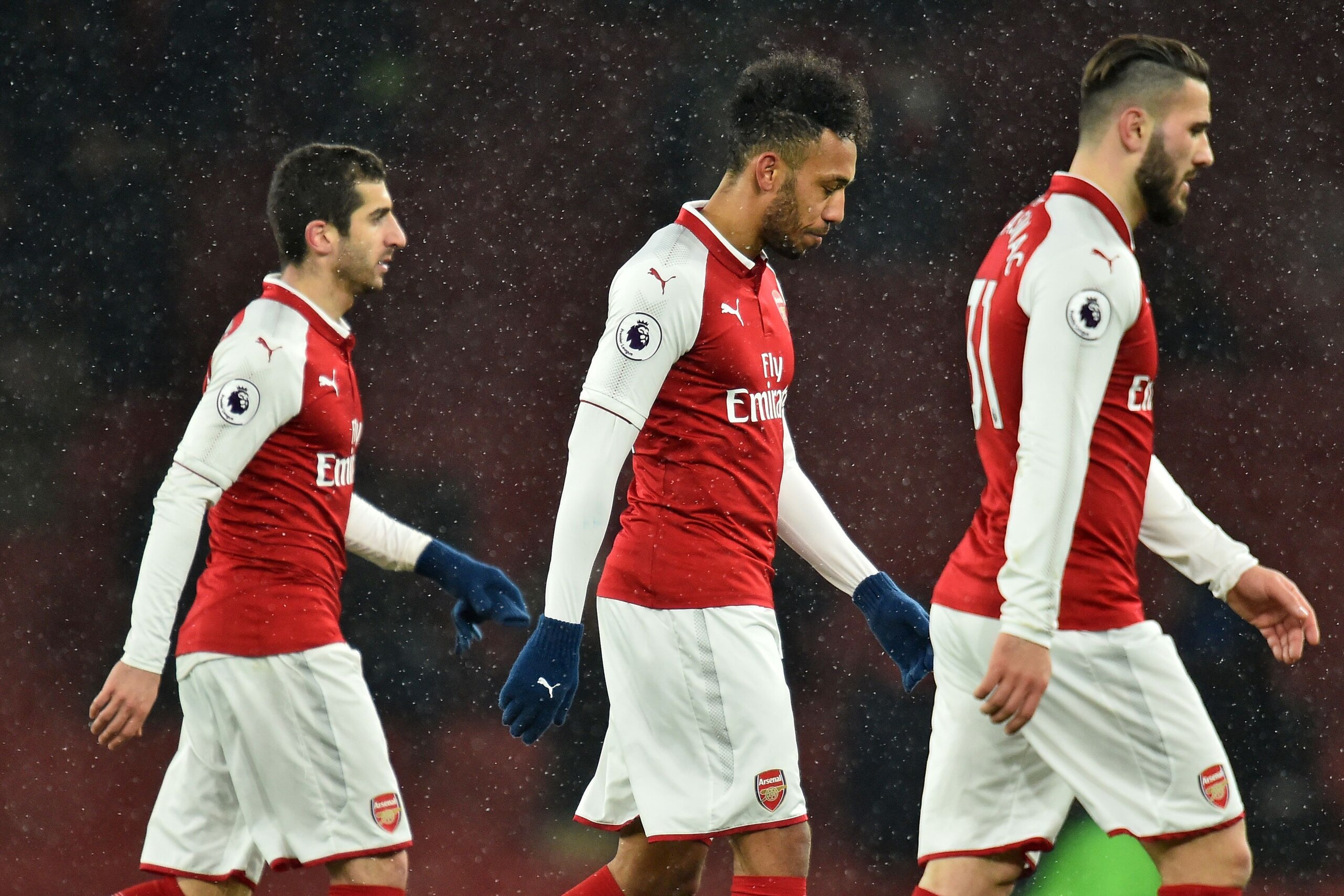 Arsenal's Armenian midfielder Henrikh Mkhitaryan (L), Arsenal's Gabonese striker Pierre-Emerick Aubameyang (C) and Arsenal's German-born Bosnian defender Sead Kolasinac (R) leave the pitch after the English Premier League football match between Arsenal an