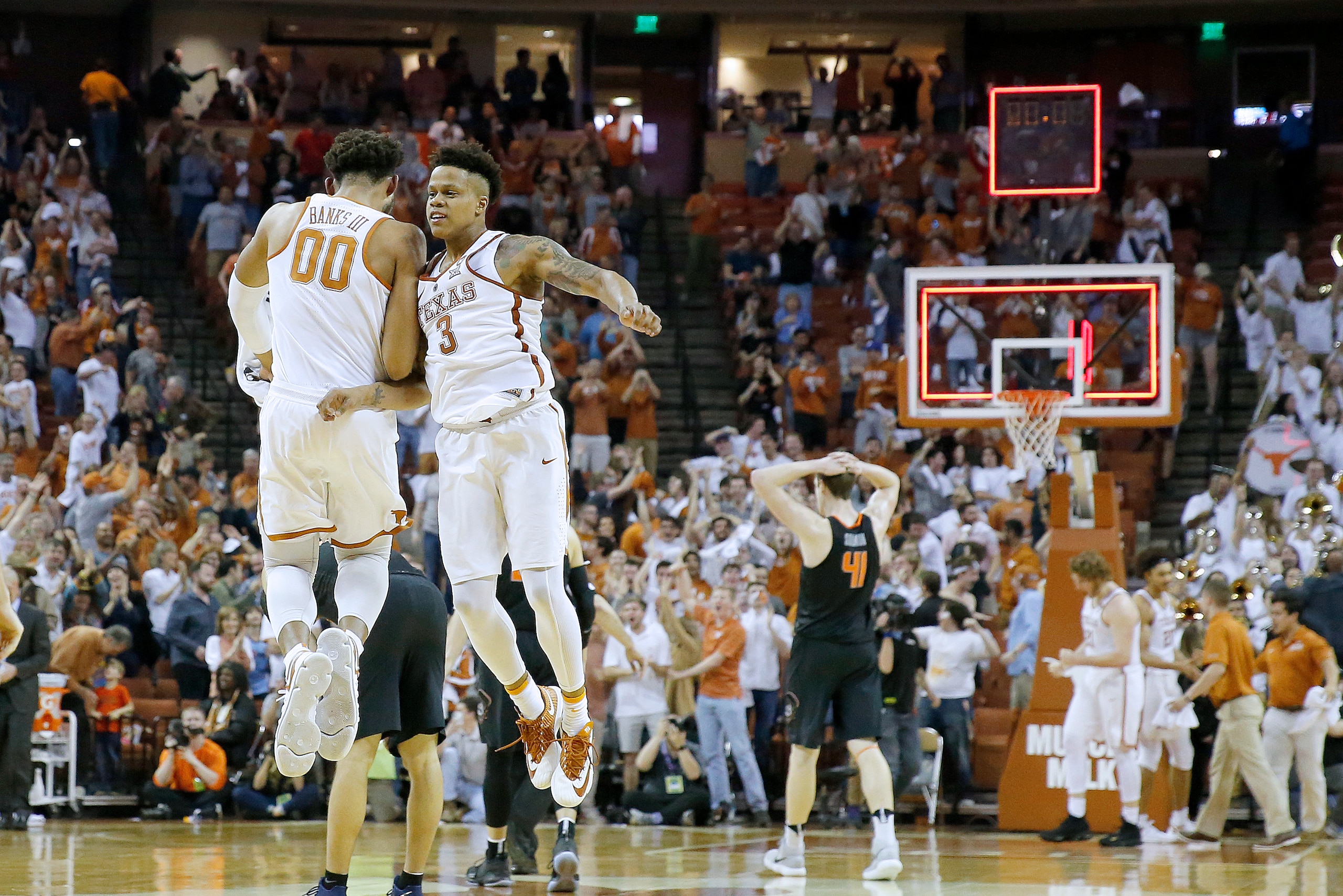 AUSTIN, TX - FEBRUARY 24: Jacob Young #3 and James Banks III #00 of the Texas Longhorns react after their team defeats the Oklahoma State Cowboys 65-64 at the Frank Erwin Center on February 24, 2018 in Austin, Texas. (Photo by Chris Covatta/Getty Images)