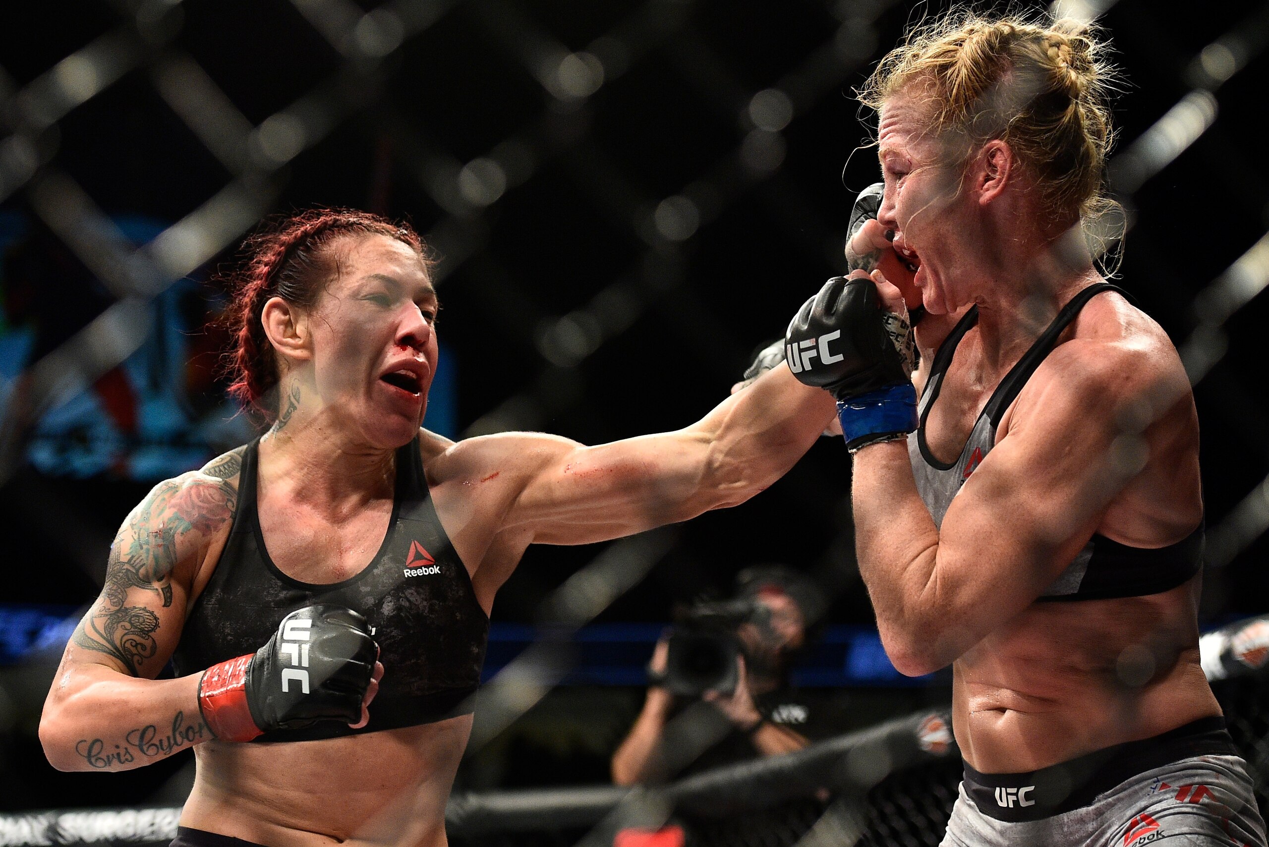 LAS VEGAS, NV - DECEMBER 30:  (L-R) Cris Cyborg of Brazil punches Holly Holm in their women's featherweight bout during the UFC 219 event inside T-Mobile Arena on December 30, 2017 in Las Vegas, Nevada. (Photo by Brandon Magnus/Zuffa LLC/Zuffa LLC via Get