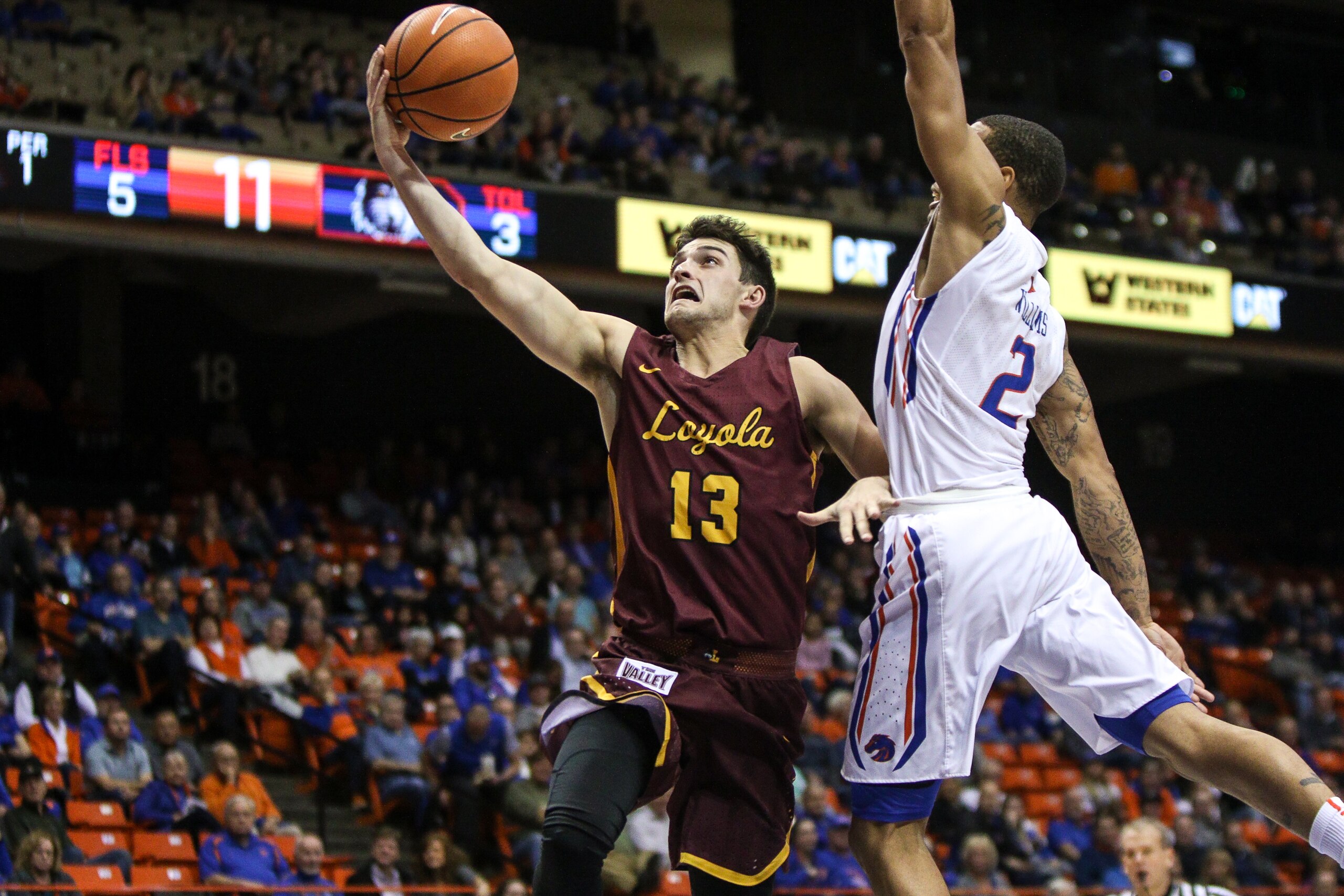 BOISE, ID - NOVEMBER 28: Guard Clayton Custer #13 of the Loyola-Chicago Ramblers shoots for two past the defense of guard Lexus Williams #2 of the Boise State Broncos during first half action on November 28, 2017 at Taco Bell Arena in Boise, Idaho. (Photo