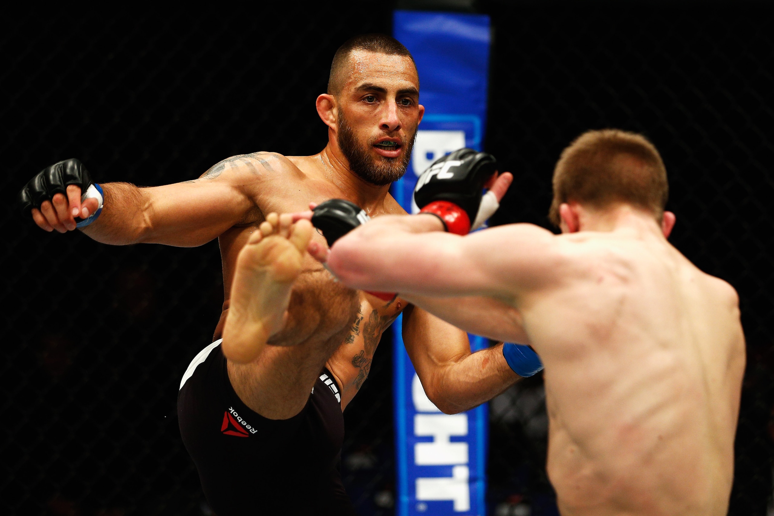 LONDON, ENGLAND - FEBRUARY 27: Yaotzin Meza of the USA (L) looks to land a high kick on Arnold 'Almighty' Allen of England during their Featherweight bout during the UFC Fight Night held at at Indigo at The O2 Arena on February 27, 2016 in London, England
