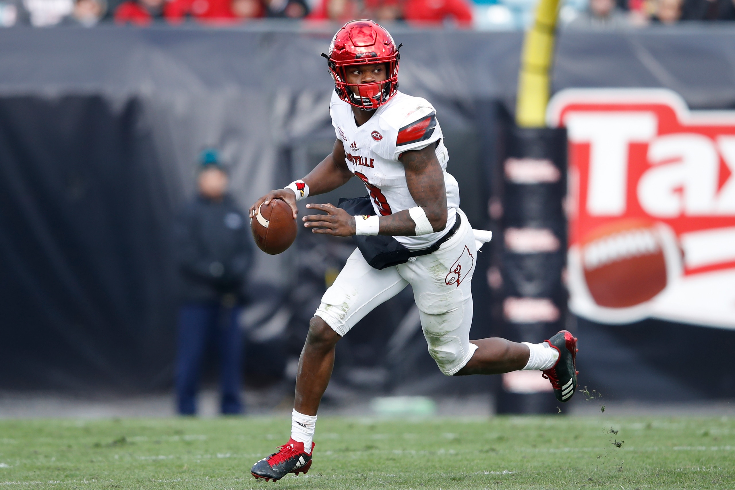 JACKSONVILLE, FL - DECEMBER 30: Lamar Jackson #8 of the Louisville Cardinals looks to pass against the Mississippi State Bulldogs during the TaxSlayer Bowl at EverBank Field on December 30, 2017 in Jacksonville, Florida. The Bulldogs won 31-27. (Photo by 