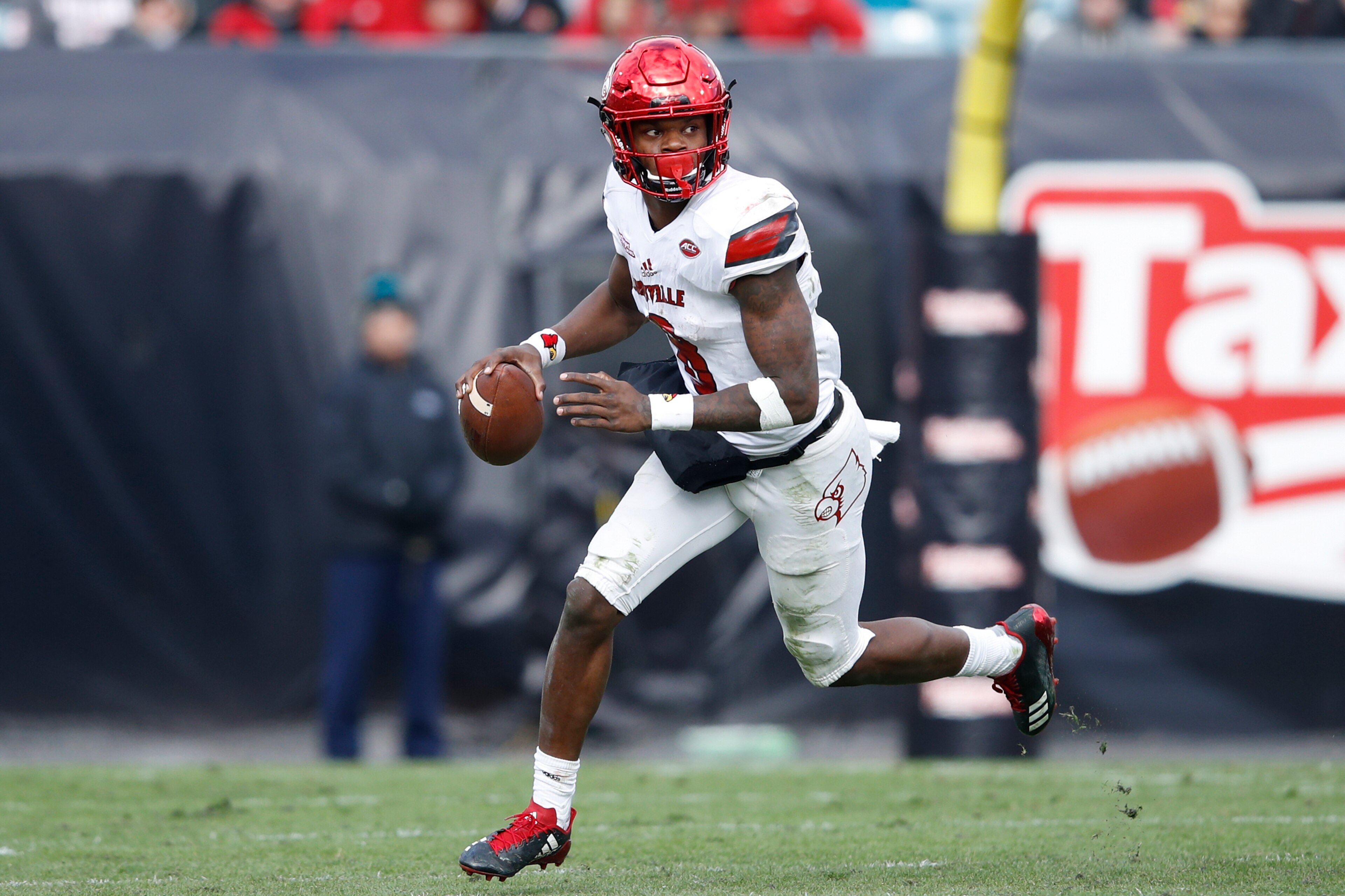 JACKSONVILLE, FL - DECEMBER 30: Lamar Jackson #8 of the Louisville Cardinals looks to pass against the Mississippi State Bulldogs during the TaxSlayer Bowl at EverBank Field on December 30, 2017 in Jacksonville, Florida. The Bulldogs won 31-27. (Photo by 