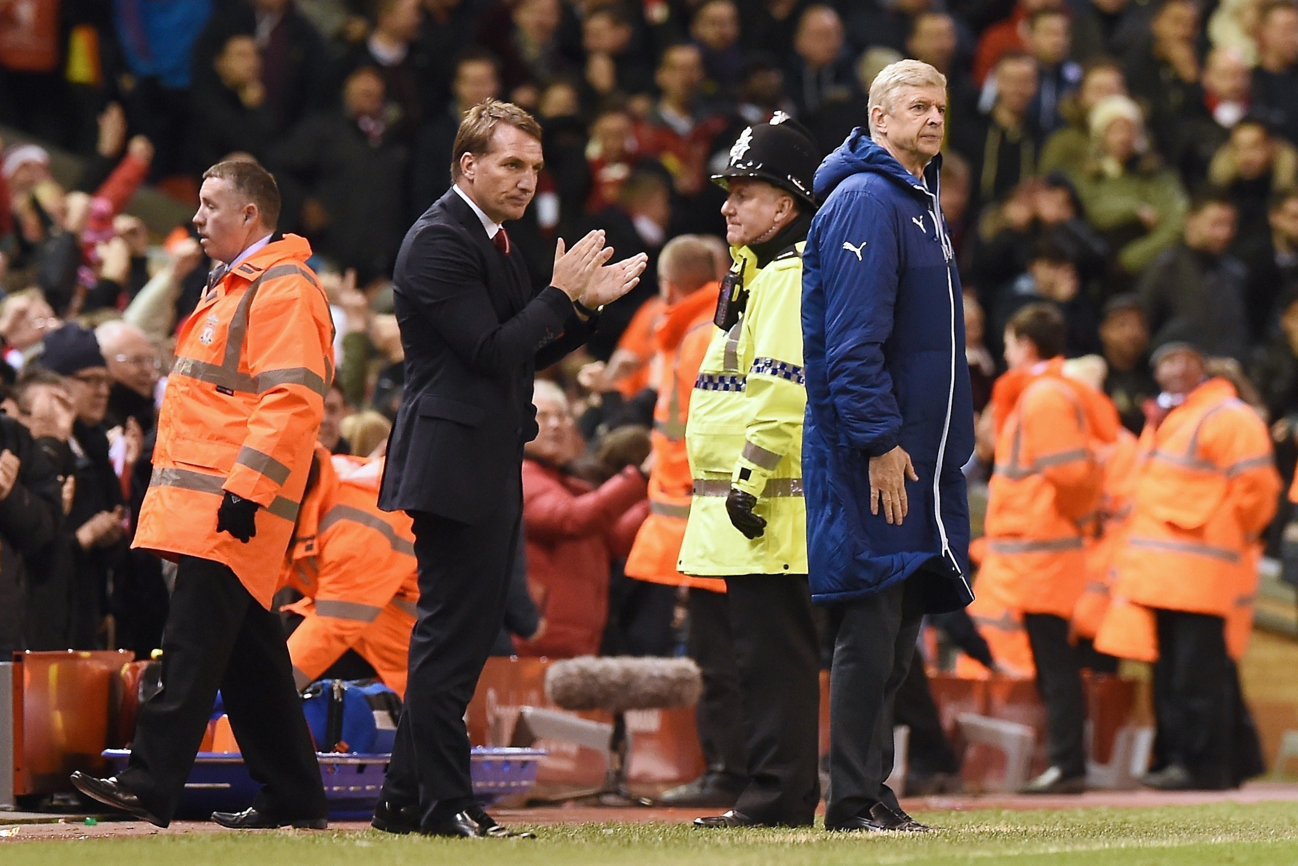 Liverpool's Northern Irish manager  Brendan Rodgers (L) and Arsenal's French manager Arsene Wenger are pictured at the end of the English Premier League football match between Liverpool and Arsenal at Anfield in Liverpool, Northwest England, on December 2