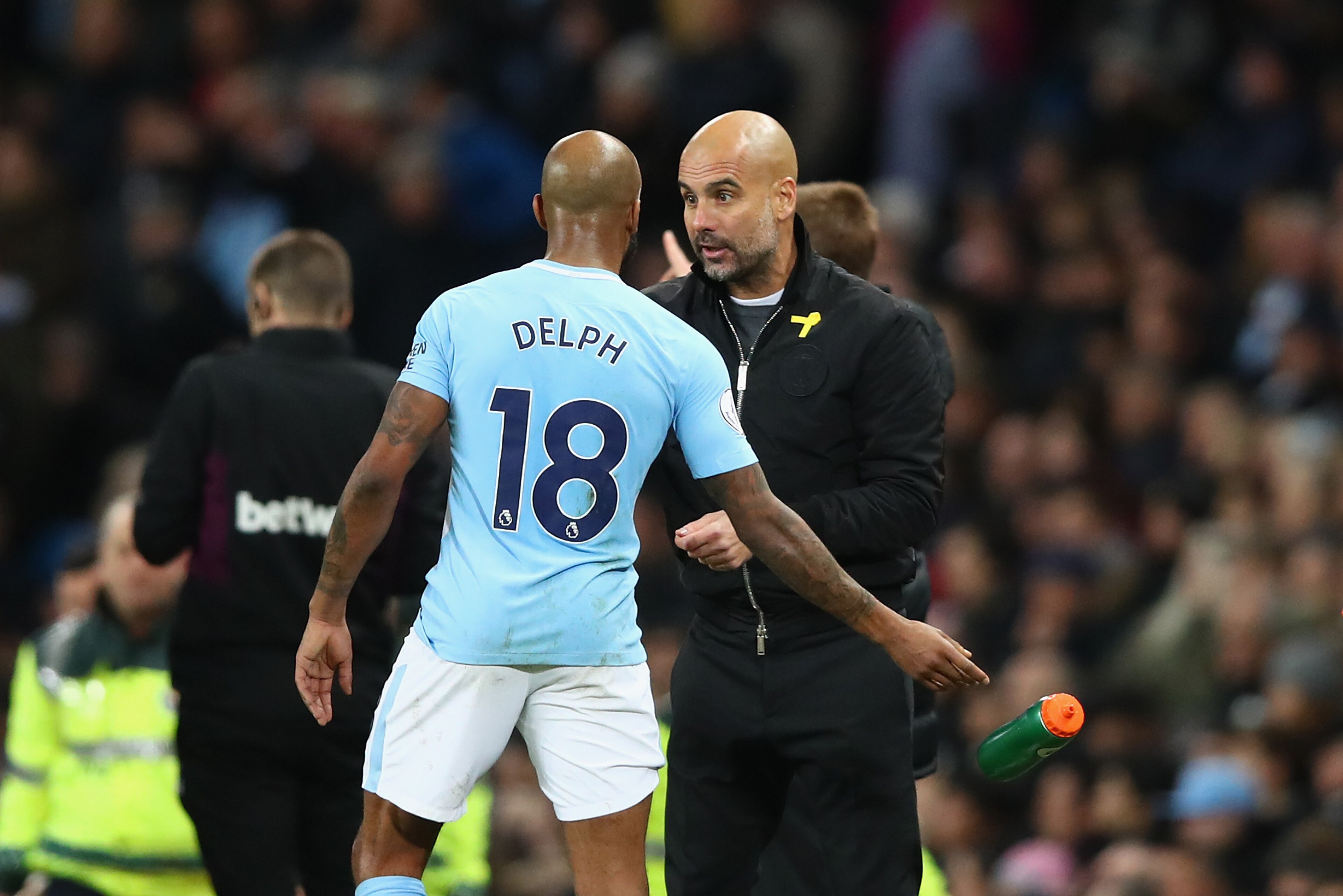 MANCHESTER, ENGLAND - DECEMBER 03:  Josep Guardiola, Manager of Manchester City and Fabian Delph of Manchester City speak during the Premier League match between Manchester City and West Ham United at Etihad Stadium on December 3, 2017 in Manchester, Engl