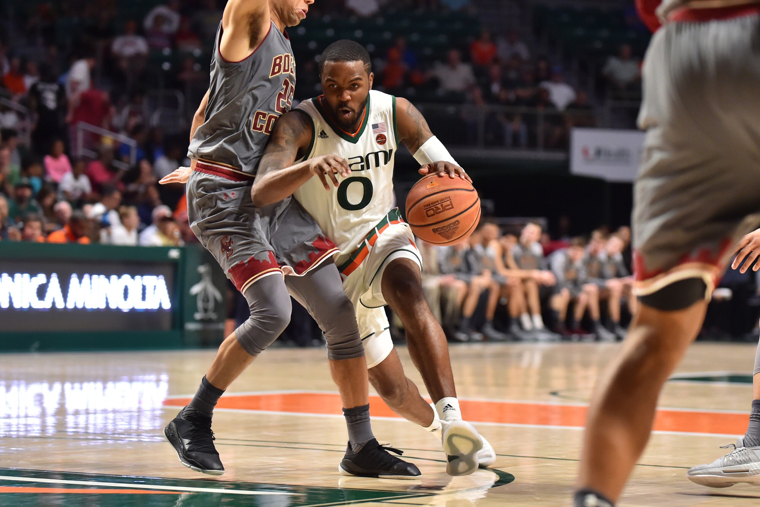 MIAMI, FL - FEBRUARY 24: Ja'Quan Newton #0 of the Miami Hurricanes drives to the basket while being defended by Jordan Chatman #25 of the Boston College Eagles during the second half of the game at The Watsco Center on February 24, 2018 in Miami, Florida.