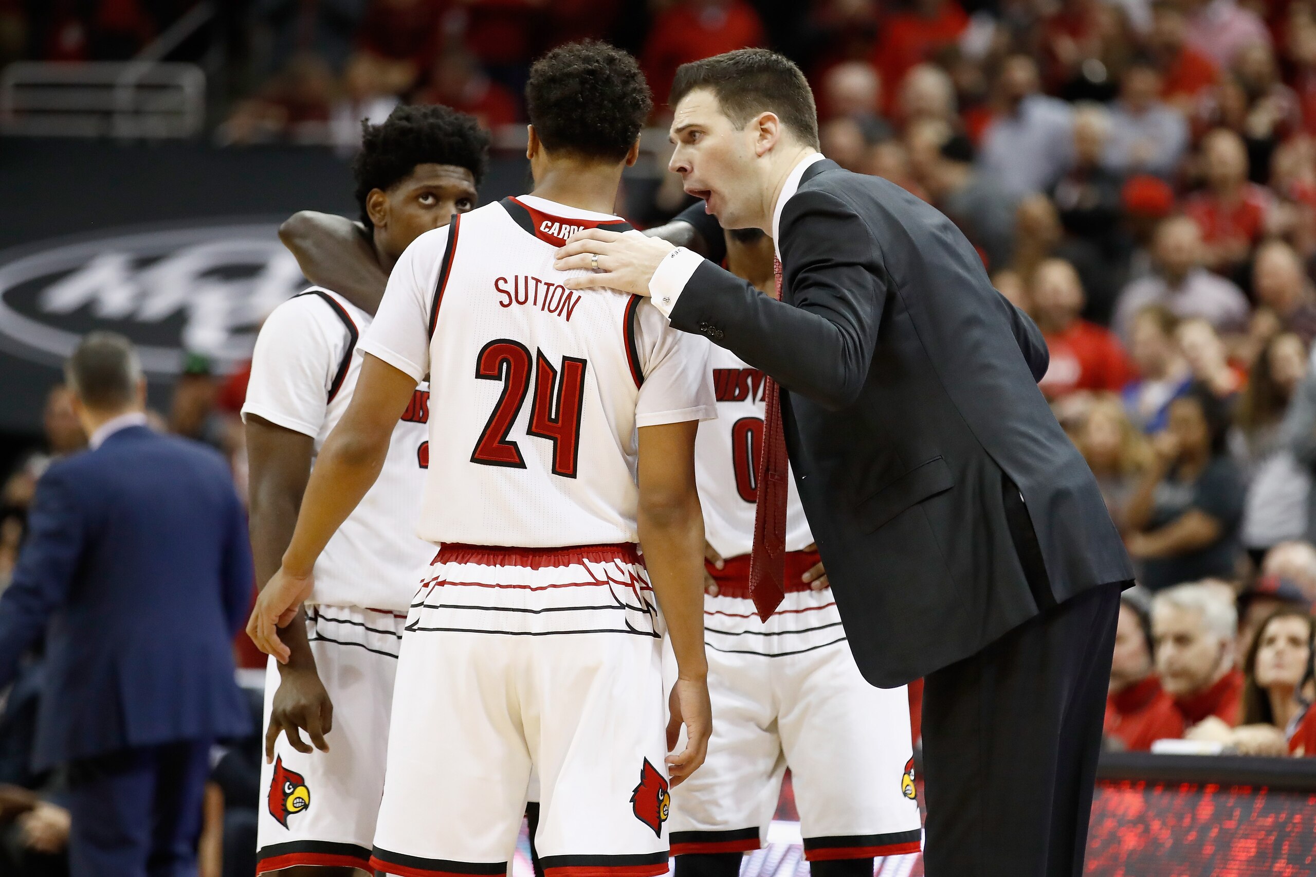 LOUISVILLE, KY - MARCH 01:  David Padgett the interim head coach of the  Louisville Cardinals gives instructions to his team against the Virginia Cavaliers during the game at KFC YUM! Center on March 1, 2018 in Louisville, Kentucky.  (Photo by Andy Lyons/