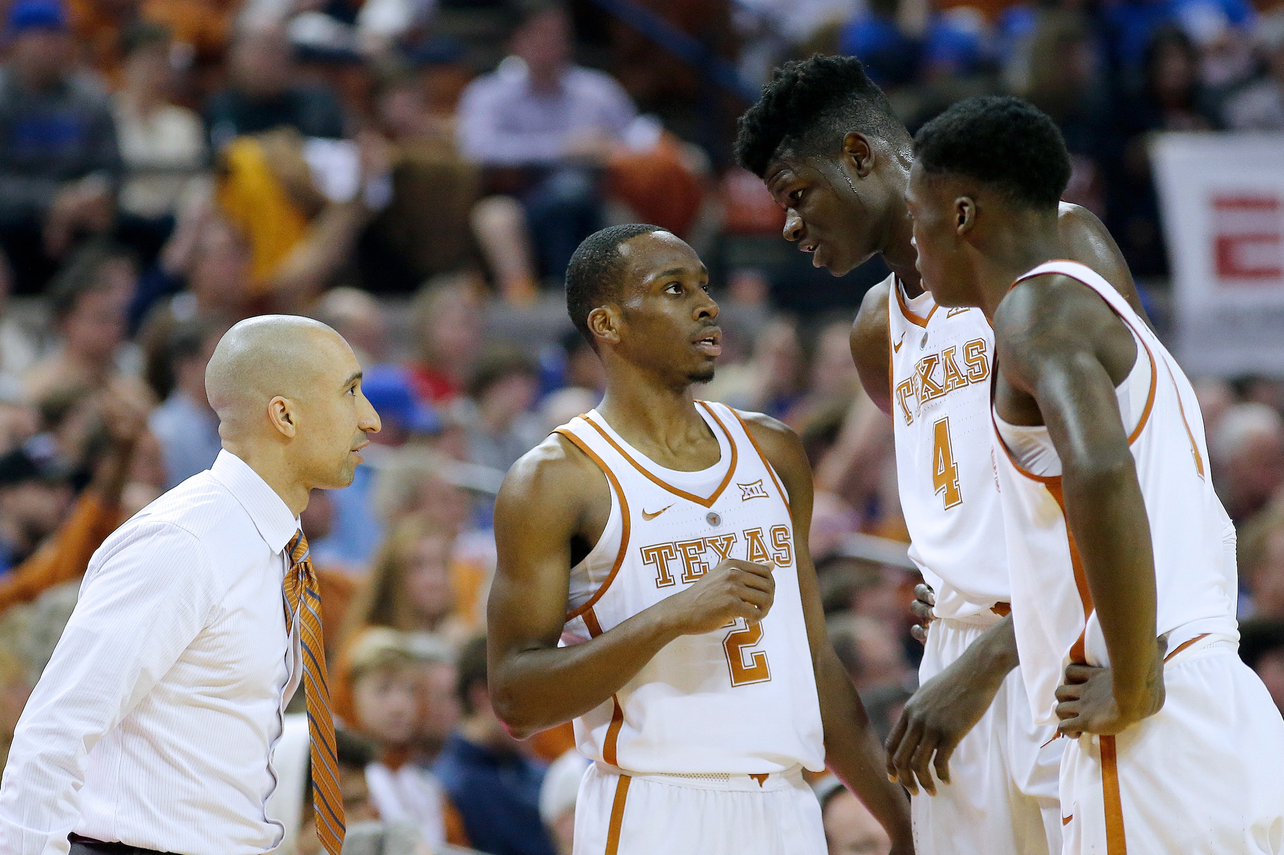 AUSTIN, TX - DECEMBER 29: Head coach Shaka Smart listens as Matt Coleman #2 gives instructions to Mohamed Bamba #4 and Andrew Jones #1 of the Texas Longhorns during the game with the Kansas Jayhawks at the Frank Erwin Center on December 29, 2017 in Austin