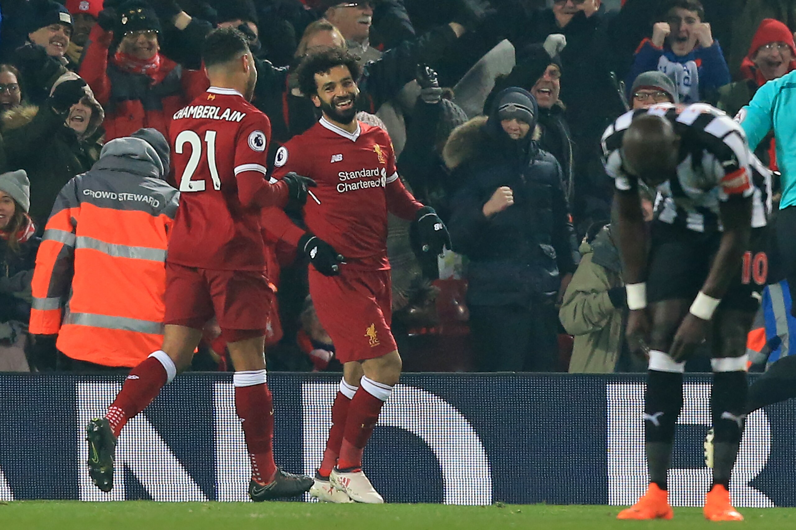 Liverpool's Egyptian midfielder Mohamed Salah (C) celebrates with Liverpool's English midfielder Alex Oxlade-Chamberlain (L) after scoring the opening goal of the English Premier League football match between Liverpool and Newcastle at Anfield in Liverpoo Liverpool's Egyptian midfielder Mohamed Salah (C) celebrates with Liverpool's English midfielder Alex Oxlade-Chamberlain (L) after scoring the opening goal of the English Premier League football match between Liverpool and Newcastle at Anfield in Liverpoo