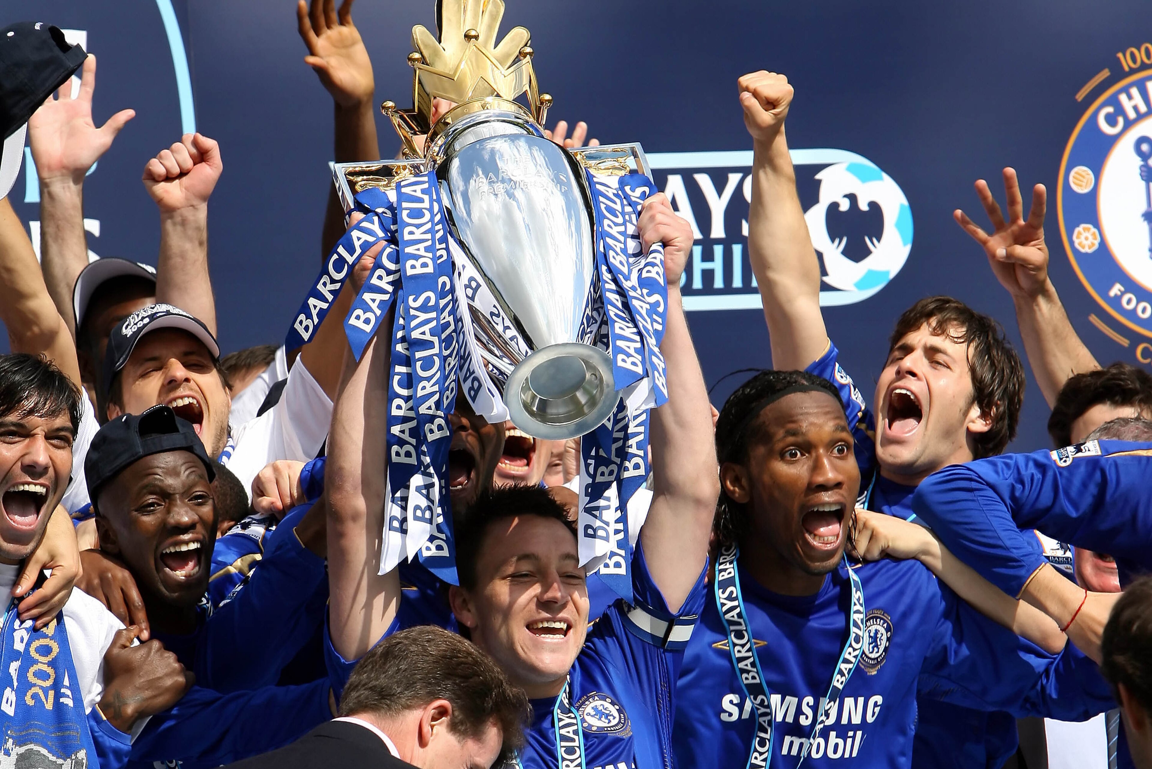 Chelsea's Captain John Terry (C) lifts the Premiership trophy alongside Didier Drogba (2nd R) and Joe Cole (R) after defeating Manchester United to win the Premiership title at Stamford Bridge in London 29 April 2006. Chelsea won the game 3.0. AFP PHOTO A Chelsea's Captain John Terry (C) lifts the Premiership trophy alongside Didier Drogba (2nd R) and Joe Cole (R) after defeating Manchester United to win the Premiership title at Stamford Bridge in London 29 April 2006. Chelsea won the game 3.0. AFP PHOTO A