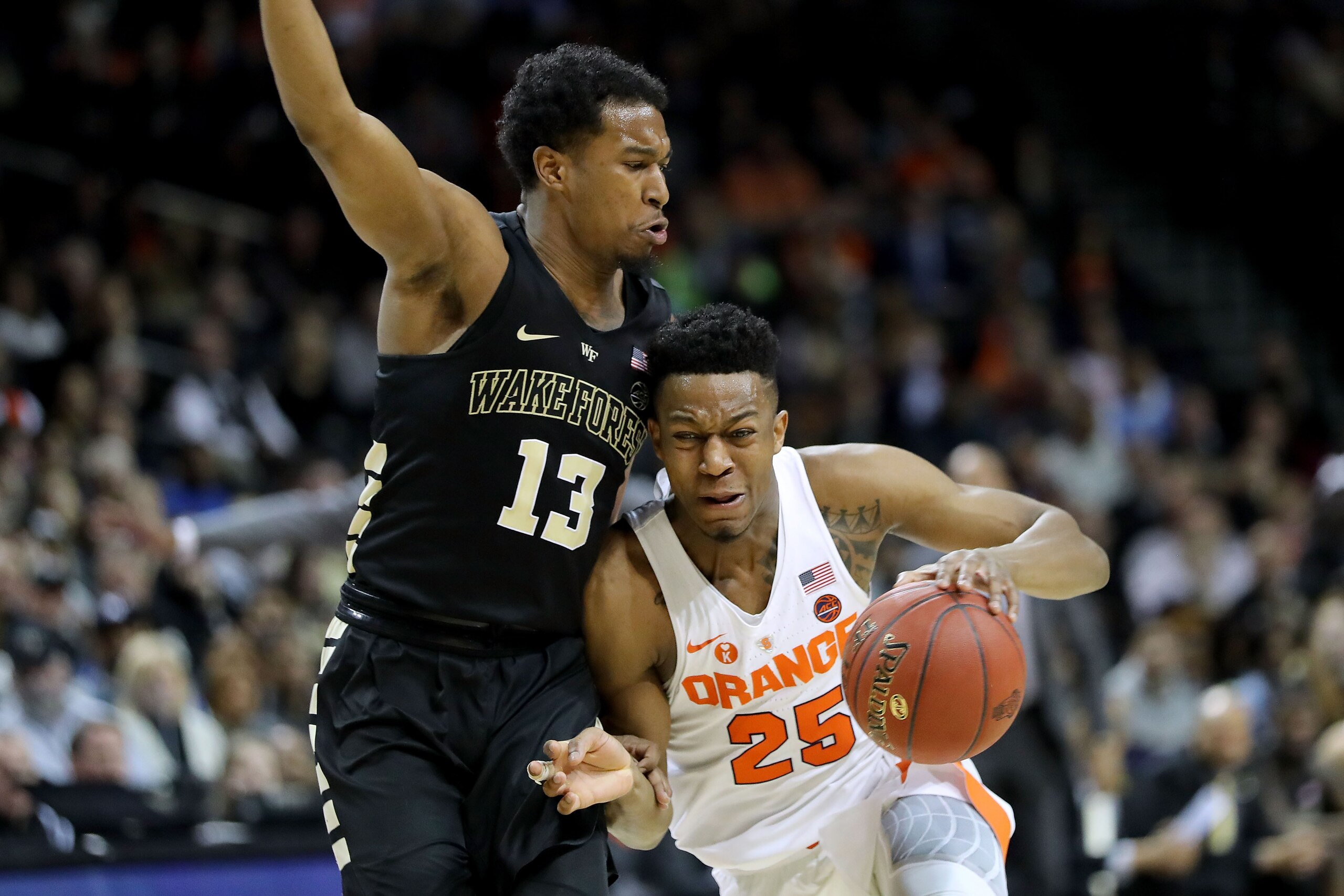 NEW YORK, NY - MARCH 06: Tyus Battle (25) of the Syracuse Orange works against Bryant Crawford (13) of the Wake Forest Demon Deacons in the second half during the first round of the ACC Men's Basketball Tournament at Barclays Center on March 6, 2018 in Ne