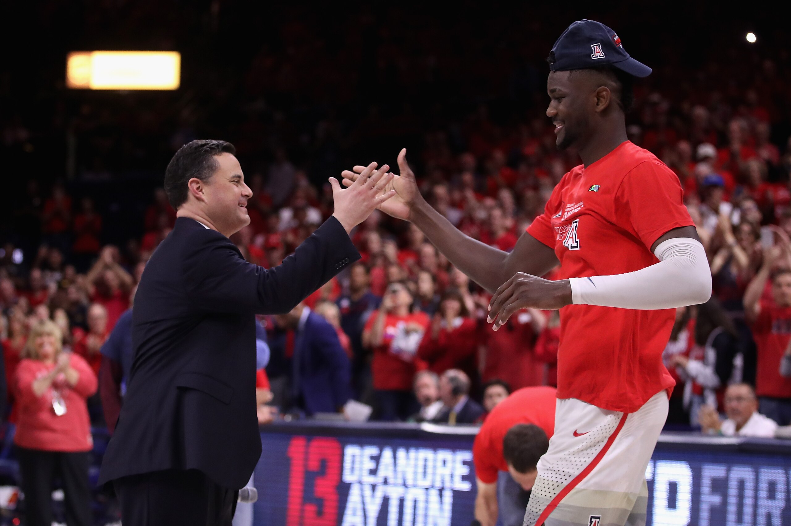 TUCSON, AZ - MARCH 03:  Head coach Sean Miller of the Arizona Wildcats greets Deandre Ayton #13 after defeating the California Golden Bears 66-54 to win the PAC-12 Championship at McKale Center on March 3, 2018 in Tucson, Arizona.  (Photo by Christian Pet