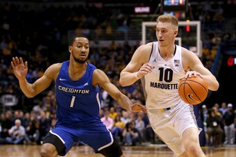 MILWAUKEE, WI - MARCH 03:  Sam Hauser #10 of the Marquette Golden Eagles dribbles the ball while being guarded by Davion Mintz #1 of the Creighton Bluejays in the first half at the BMO Harris Bradley Center on March 3, 2018 in Milwaukee, Wisconsin. (Photo