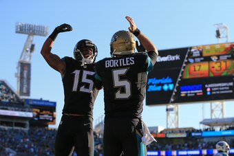 JACKSONVILLE, FL - DECEMBER 24: Blake Bortles #5 of the Jacksonville Jaguars celebrates with Allen Robinson #15 after scoring a touchdown off a pass from Marquise Lee, not pictured, during the fourth quarter of the game against the Tennessee Titans at Eve
