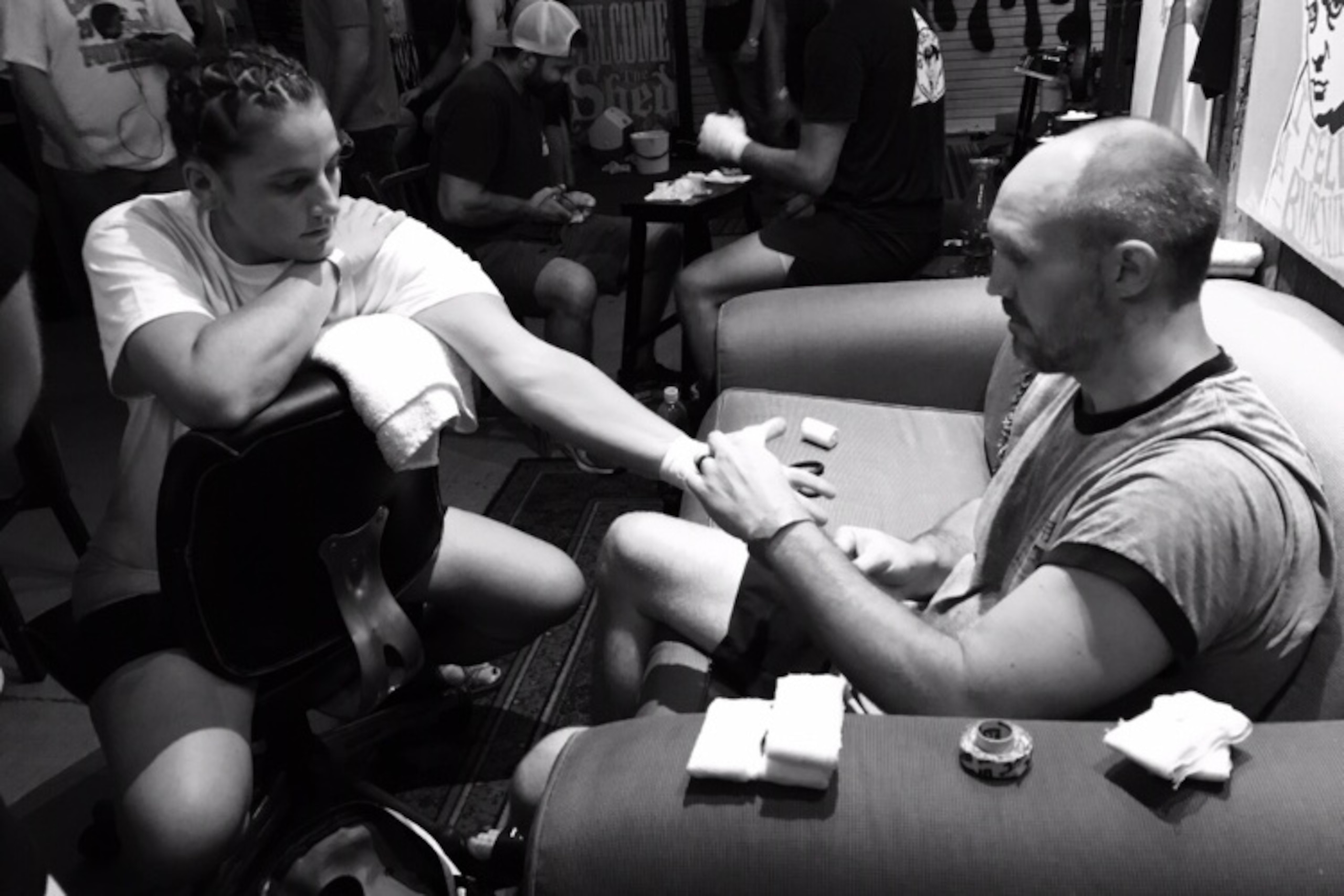 Coach Eric Turner wraps Olivia Parker's hands before an MMA fight.