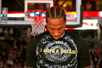 SAN ANTONIO,TX - JANUARY 13 :  Kawhi Leonard #2 of the San Antonio Spurs bows his head during the playing of the National Anthem before the start of his game against the Denver Nuggets at AT&T Center on January 13, 2018  in San Antonio, Texas.  NOTE TO US