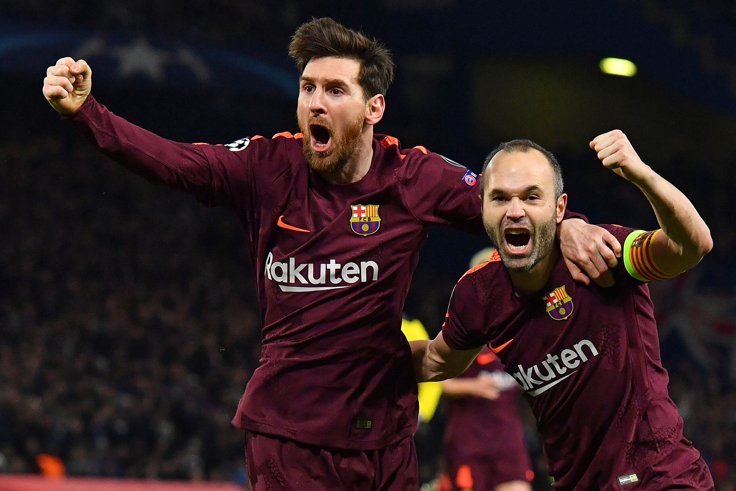 TOPSHOT - Barcelona's Argentinian striker Lionel Messi (L) celebrates with Barcelona's Spanish midfielder Andres Iniesta (R) after scoring their first goal during the first leg of the UEFA Champions League round of 16 football match between Chelsea and Ba