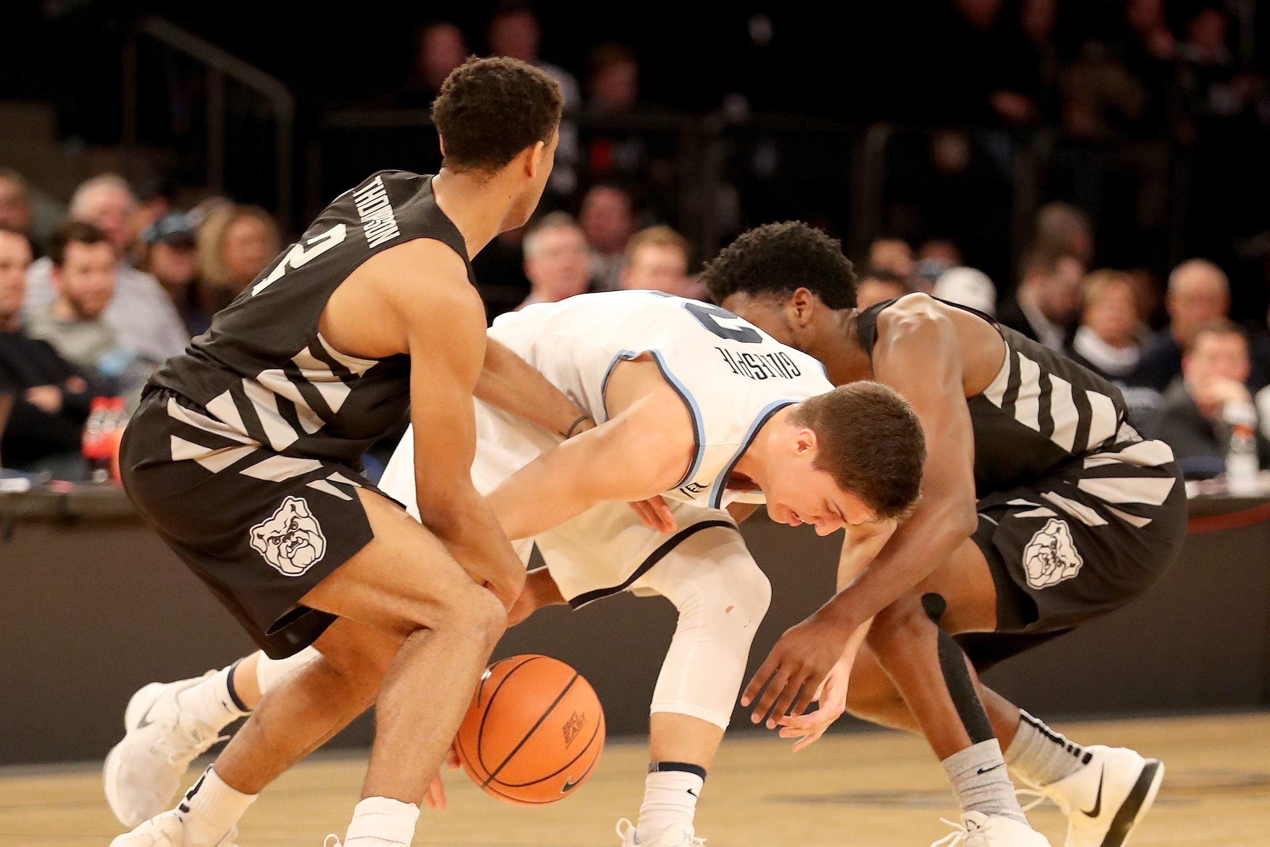 NEW YORK, NY - MARCH 09:  Aaron Thompson #2 and Kamar Baldwin #3 of the Butler Bulldogs fight for the ball with Collin Gillespie #2 of the Villanova Wildcats in the second half during semifinals of the Big East Basketball Tournament at Madison Square Gard