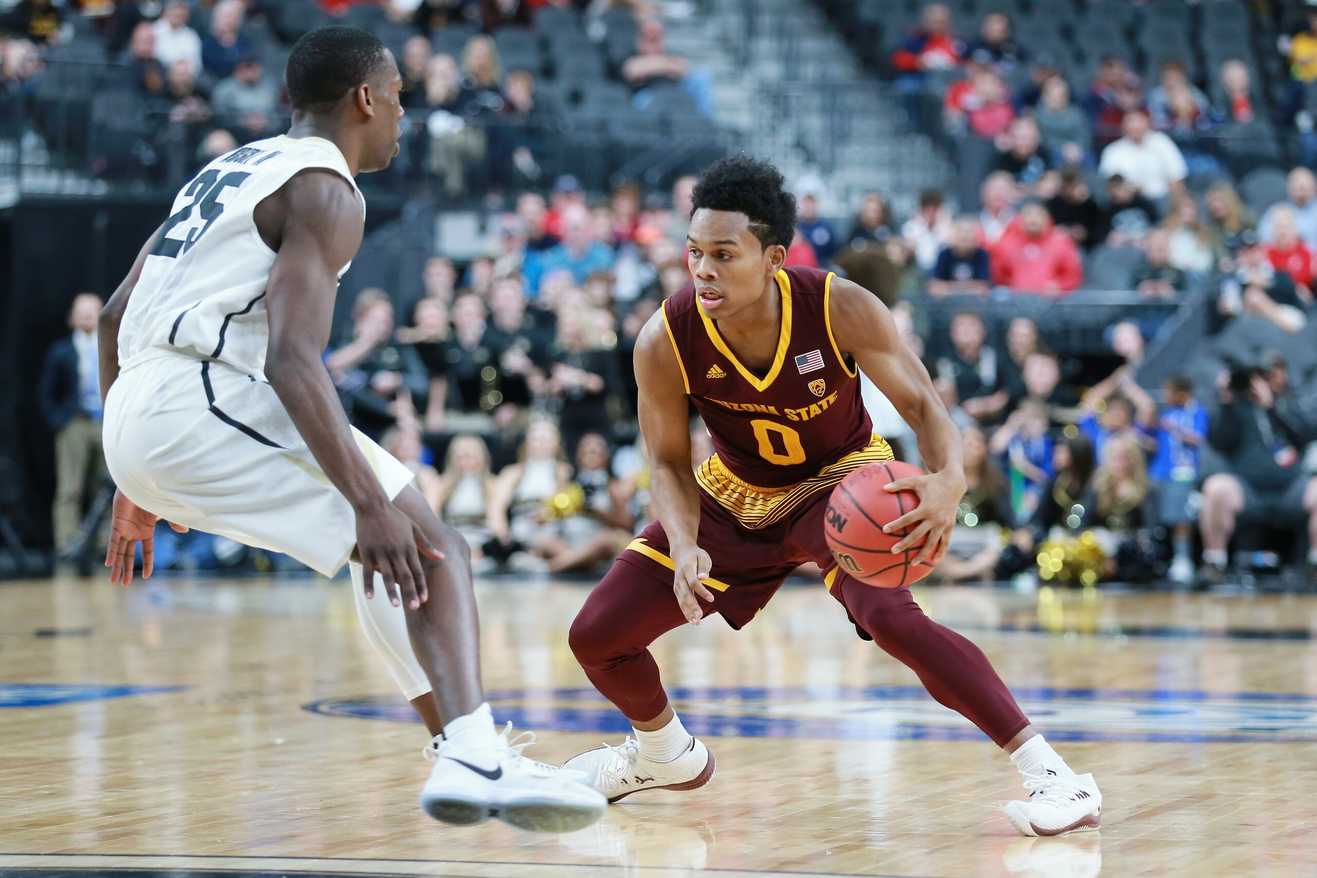 LAS VEGAS, NV - MARCH 07: Tra Holder #0 of the Arizona State Sun Devils handles the ball against McKinley Wright IV #25 of the Colorado Buffaloes during a first-round game of the Pac-12 basketball tournament at T-Mobile Arena on March 7, 2018 in Las Vegas