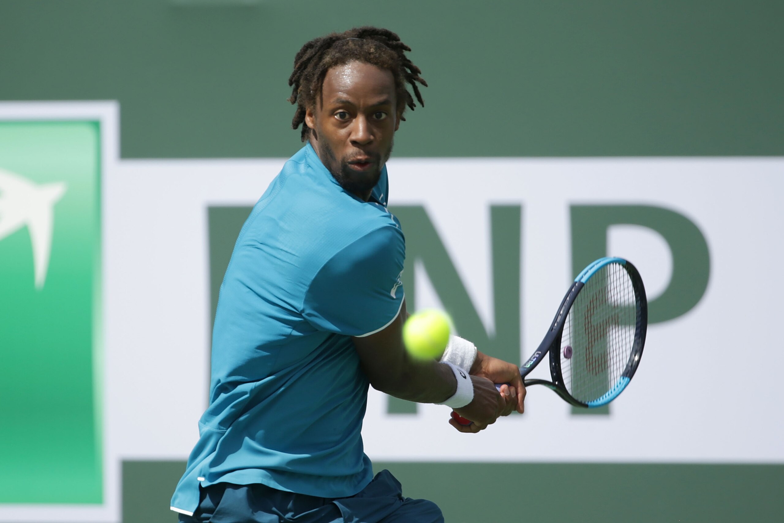 INDIAN WELLS, CA - MARCH 11:  Gael Monfils of France returns a backhand to John Isner during the BNP Paribas Open on March 11, 2018 at the Indian Wells Tennis Garden in Indian Wells, California.  (Photo by Jeff Gross/Getty Images)