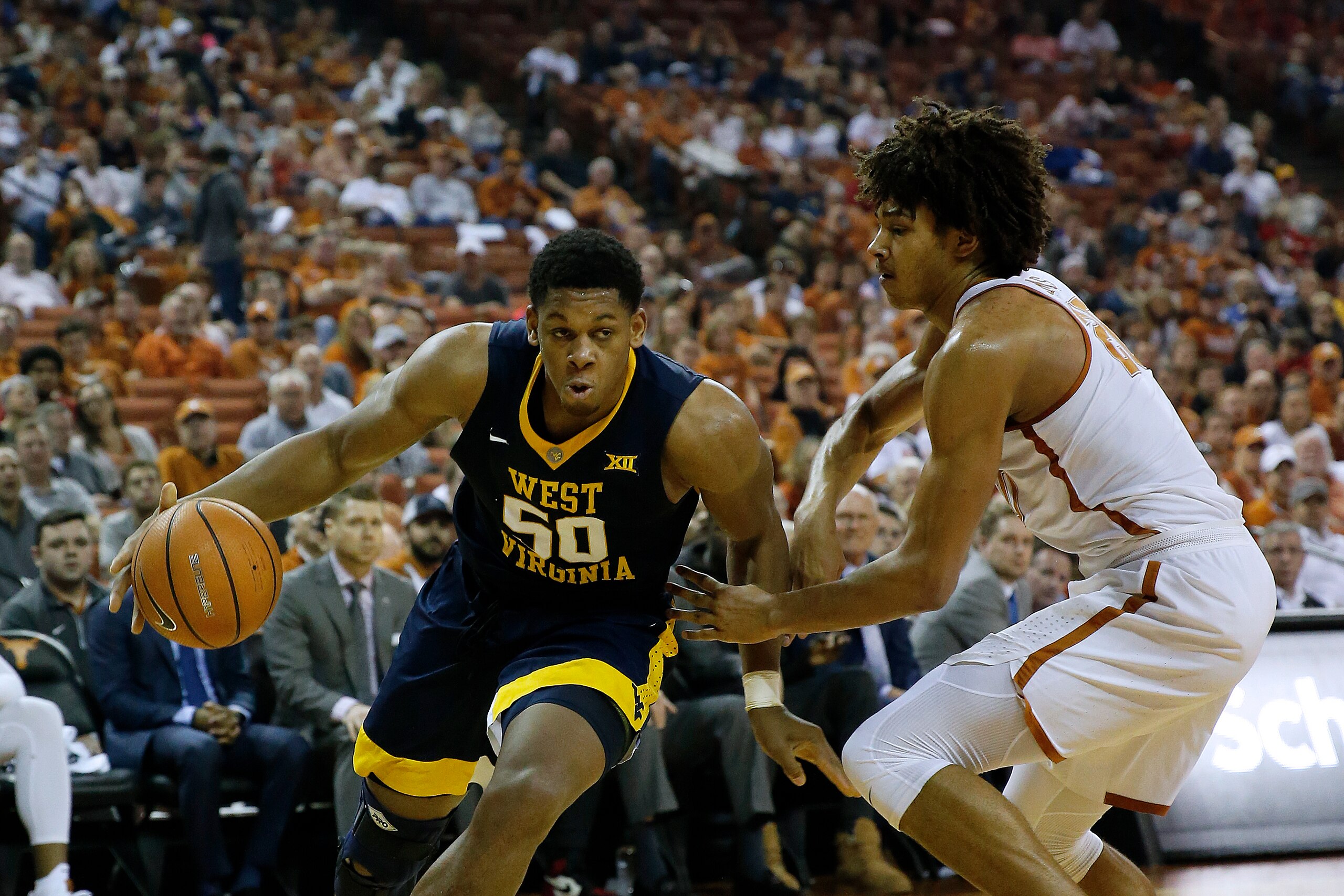 AUSTIN, TX - MARCH 3: Sagaba Konate #50 of the West Virginia Mountaineers drives around Jericho Sims #20 of the Texas Longhorns at the Frank Erwin Center on March 3, 2018 in Austin, Texas. (Photo by Chris Covatta/Getty Images)