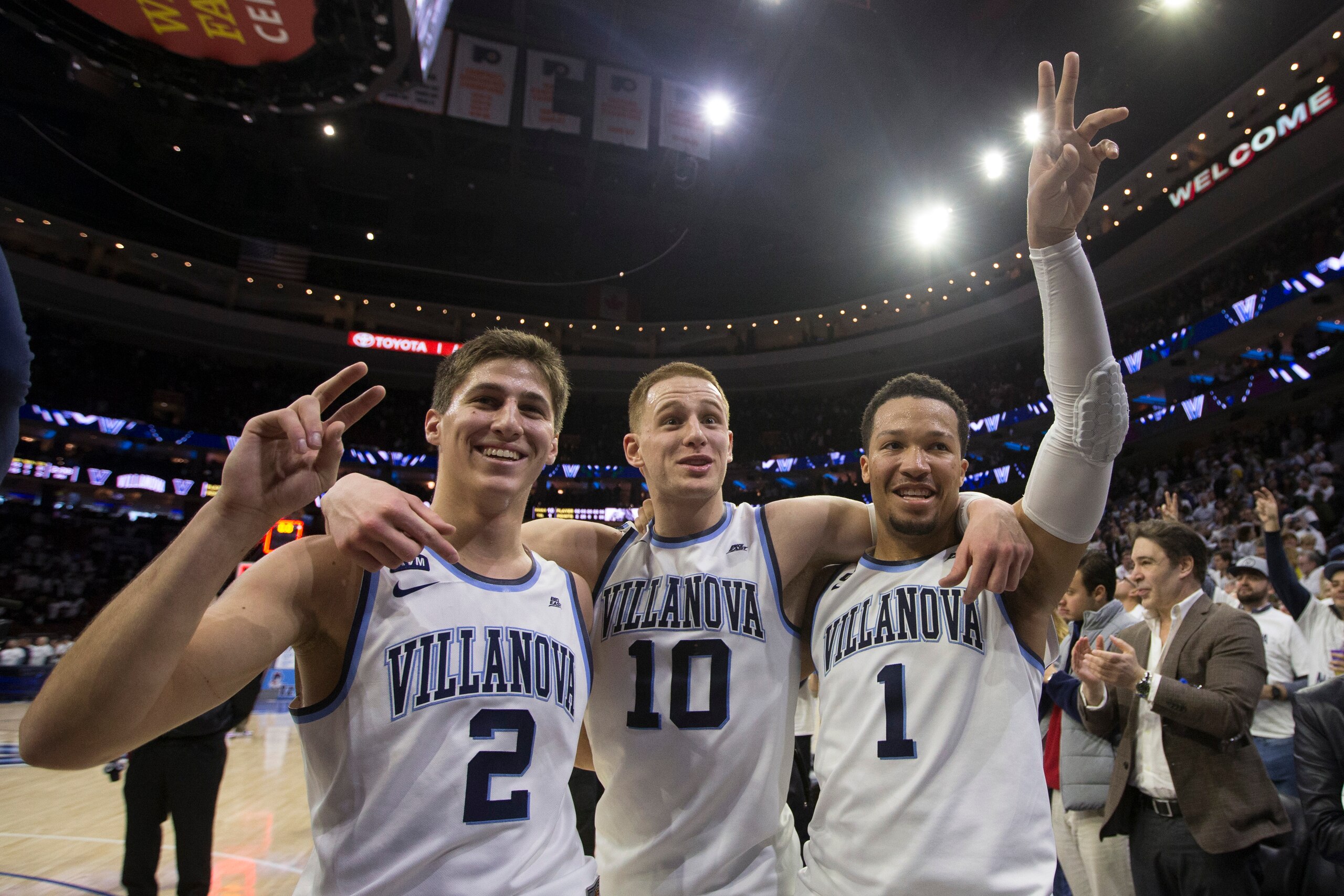 PHILADELPHIA, PA - FEBRUARY 10: Collin Gillespie #2, Donte DiVincenzo #10, and Jalen Brunson #1 of the Villanova Wildcats salute the student section after the game against the Butler Bulldogs at the Wells Fargo Center on February 10, 2018 in Philadelphia,