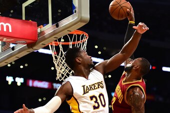 LOS ANGELES, CA - MARCH 19:  LeBron James #23 of the Cleveland Cavaliers dunks over Julius Randle #30 of the Los Angeles Lakers during the first half at Staples Center on March 19, 2017 in Los Angeles, California.  NOTE TO USER: User expressly acknowledge