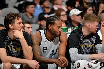 SAN ANTONIO, TX - JANUARY 13:  Pau Gasol #16 of the San Antonio Spurs, Kawhi Leonard #2 of the San Antonio Spurs, and Davis Bertans #42 of the San Antonio Spurs look on against the Denver Nuggets on January 13, 2018 at the AT&T Center in San Antonio, Texa