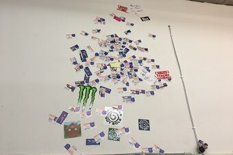 The wall at Project Blitz covered with shipping stickers placed by players showing off their vertical jumps.