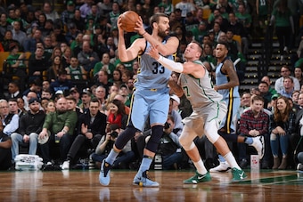 BOSTON, MA - FEBRUARY 26: Marc Gasol #33 of the Memphis Grizzlies handles the ball against Daniel Theis #27 of the Boston Celtics during the game between the two teams on February 26, 2018 at the TD Garden in Boston, Massachusetts.  NOTE TO USER: User exp
