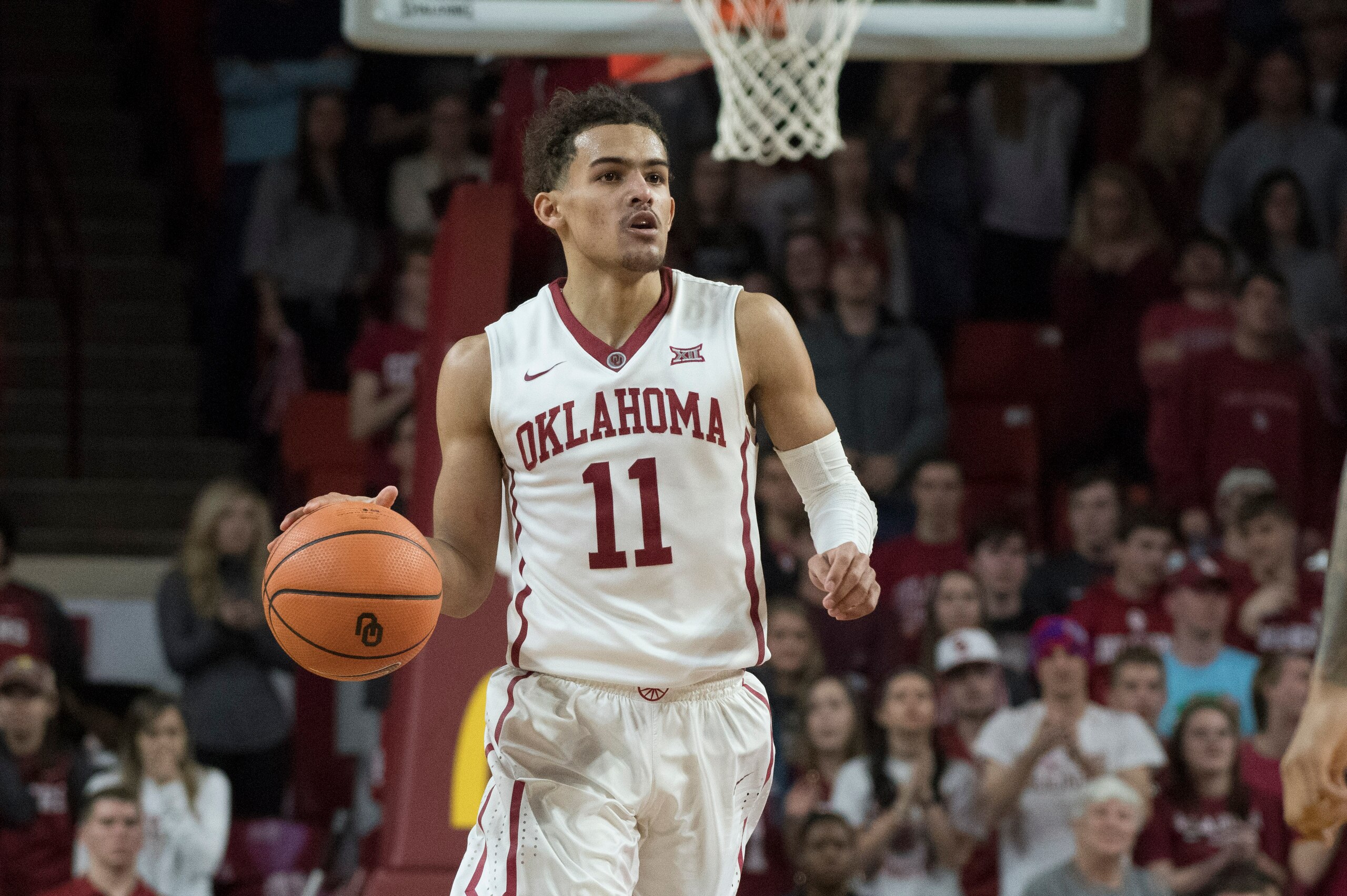 NORMAN, OK - MARCH 2:  Oklahoma Sooners guard Trae Young #11 brings the ball up court against Iowa State during the second half of a NCAA college basketball game at the Lloyd Noble Center on March 2, 2018 in Norman, Oklahoma. (Photo by J Pat Carter/Getty 