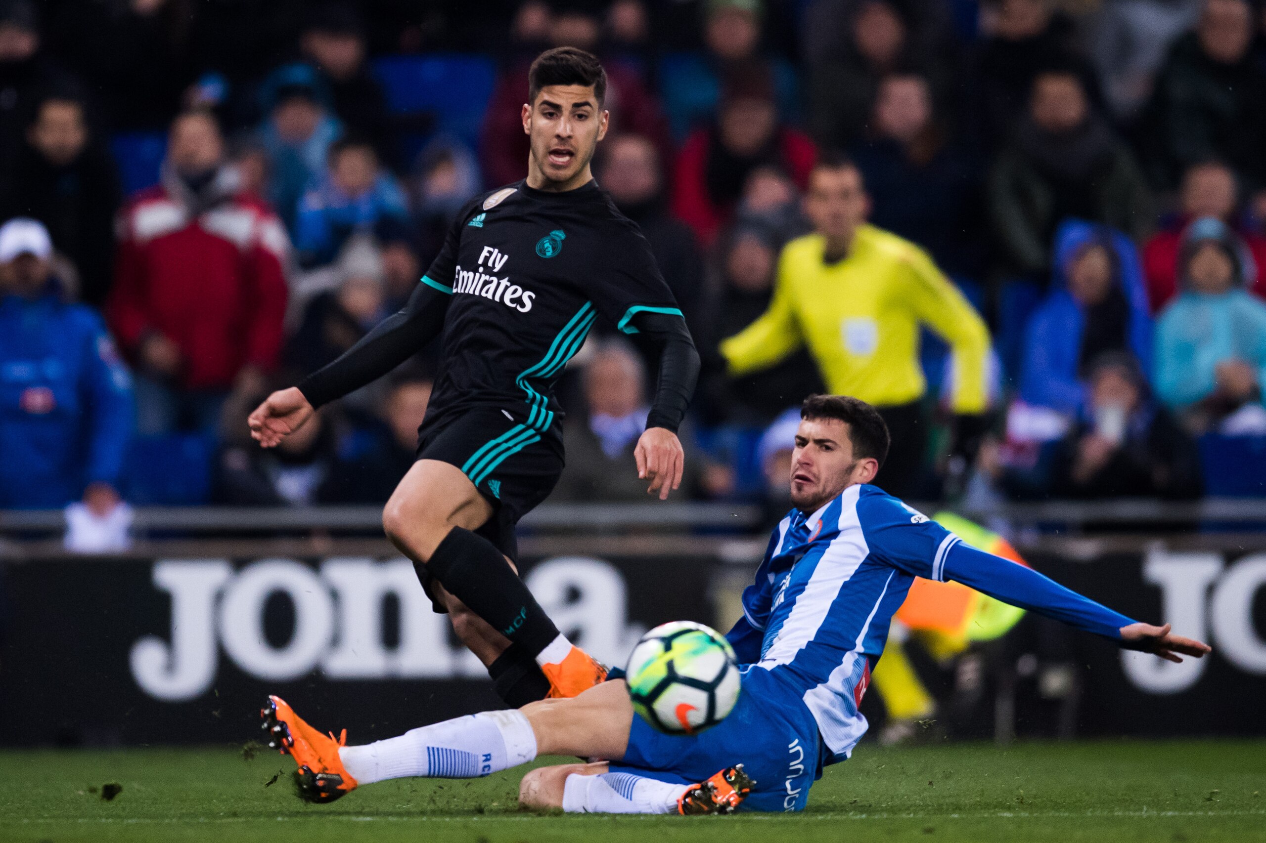 BARCELONA, SPAIN - FEBRUARY 27: Marco Asensio of Real Madrid CF plays the ball past Aaron Martin of RCD Espanyol during the La Liga match between Espanyol and Real Madrid at RCDE Stadium on February 27, 2018 in Barcelona, Spain. (Photo by Alex Caparros/Ge