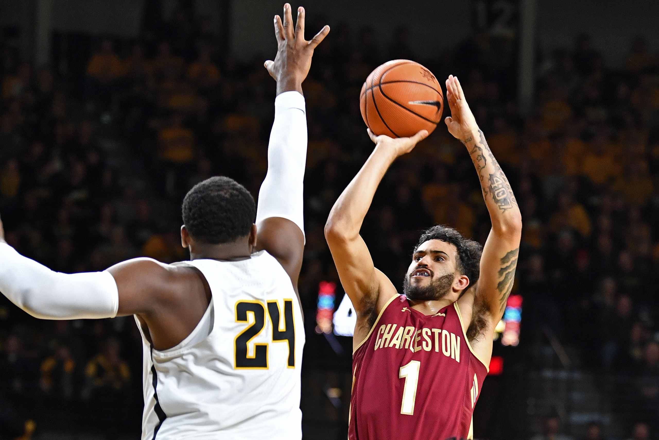 WICHITA, KS - NOVEMBER 13:  Guard Grant Riller #1 of the College of Charleston Cougars puts up a shot against forward Shaquille Morris #24 of the Wichita State Shockers during the second half on November 13, 2017 at Charles Koch Arena in Wichita, Kansas. 