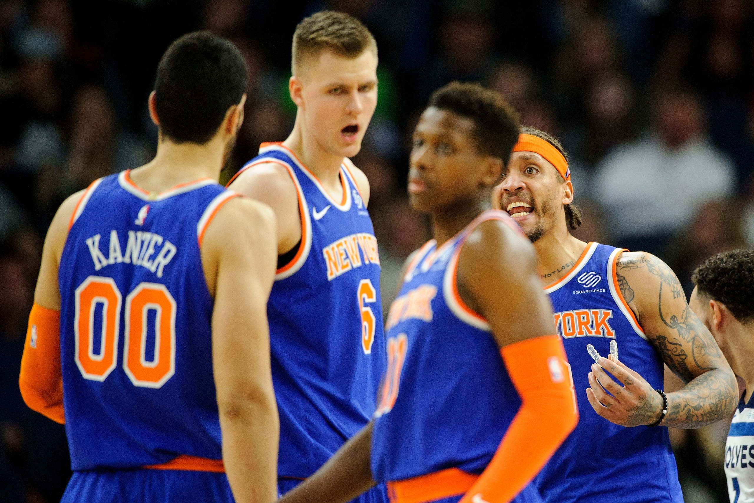 MINNEAPOLIS, MN - JANUARY 12: Michael Beasley #8 of the New York Knicks speaks with teammate Enes Kanter #00, Kristaps Porzingis #6 and Frank Ntilikina #11 during the game against the Minnesota Timberwolves on January 12, 2018 at the Target Center in Minn