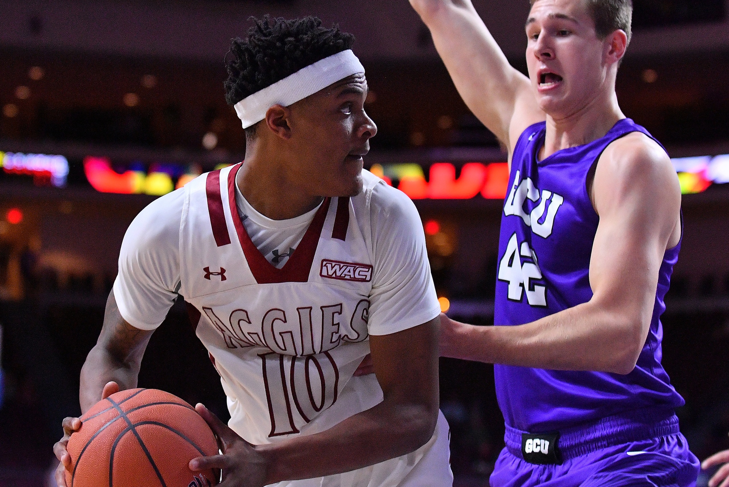 LAS VEGAS, NV - MARCH 10:  Jemerrio Jones #10 of the New Mexico State Aggies posts up against Gerard Martin #42 of the Grand Canyon Lopes during the championship game of the Western Athletic Conference basketball tournament at the Orleans Arena on March 1