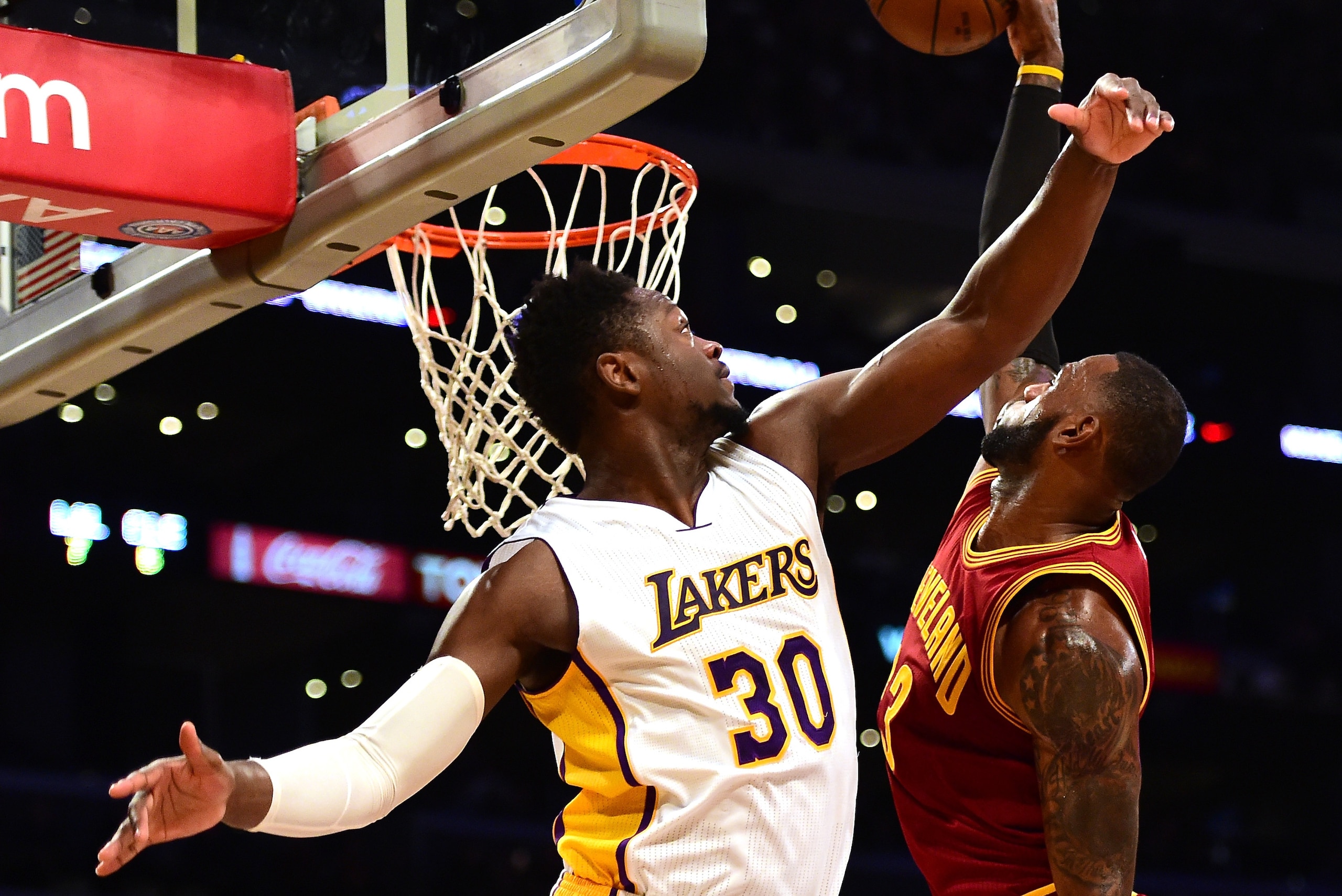 LOS ANGELES, CA - MARCH 19:  LeBron James #23 of the Cleveland Cavaliers dunks over Julius Randle #30 of the Los Angeles Lakers during the first half at Staples Center on March 19, 2017 in Los Angeles, California.  NOTE TO USER: User expressly acknowledge
