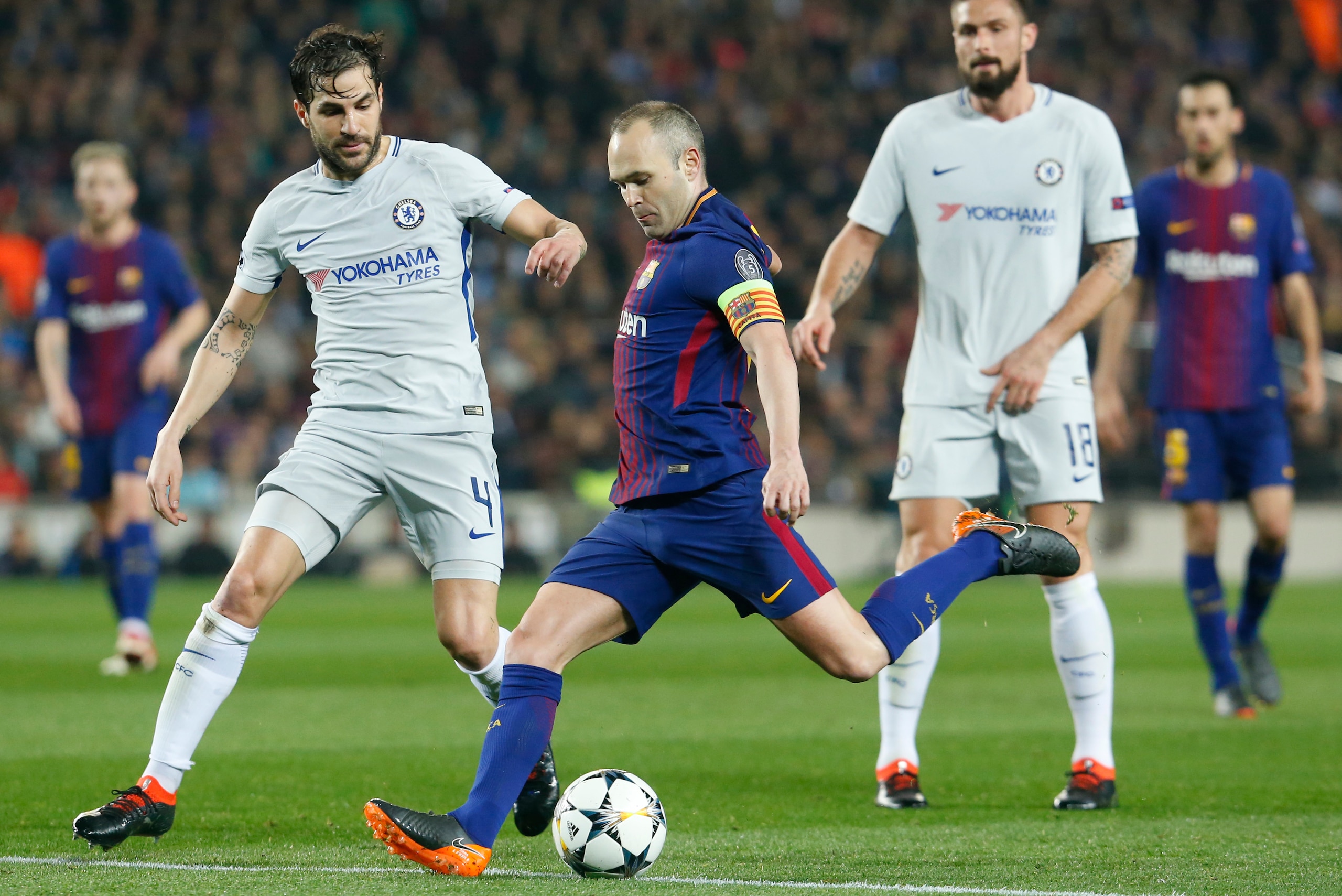 Barcelona's Spanish midfielder Andres Iniesta (C) vies with Chelsea's Spanish midfielder Cesc Fabregas (L) during the UEFA Champions League round of sixteen second leg  football match between FC Barcelona and Chelsea FC at the Camp Nou stadium in Barcelon