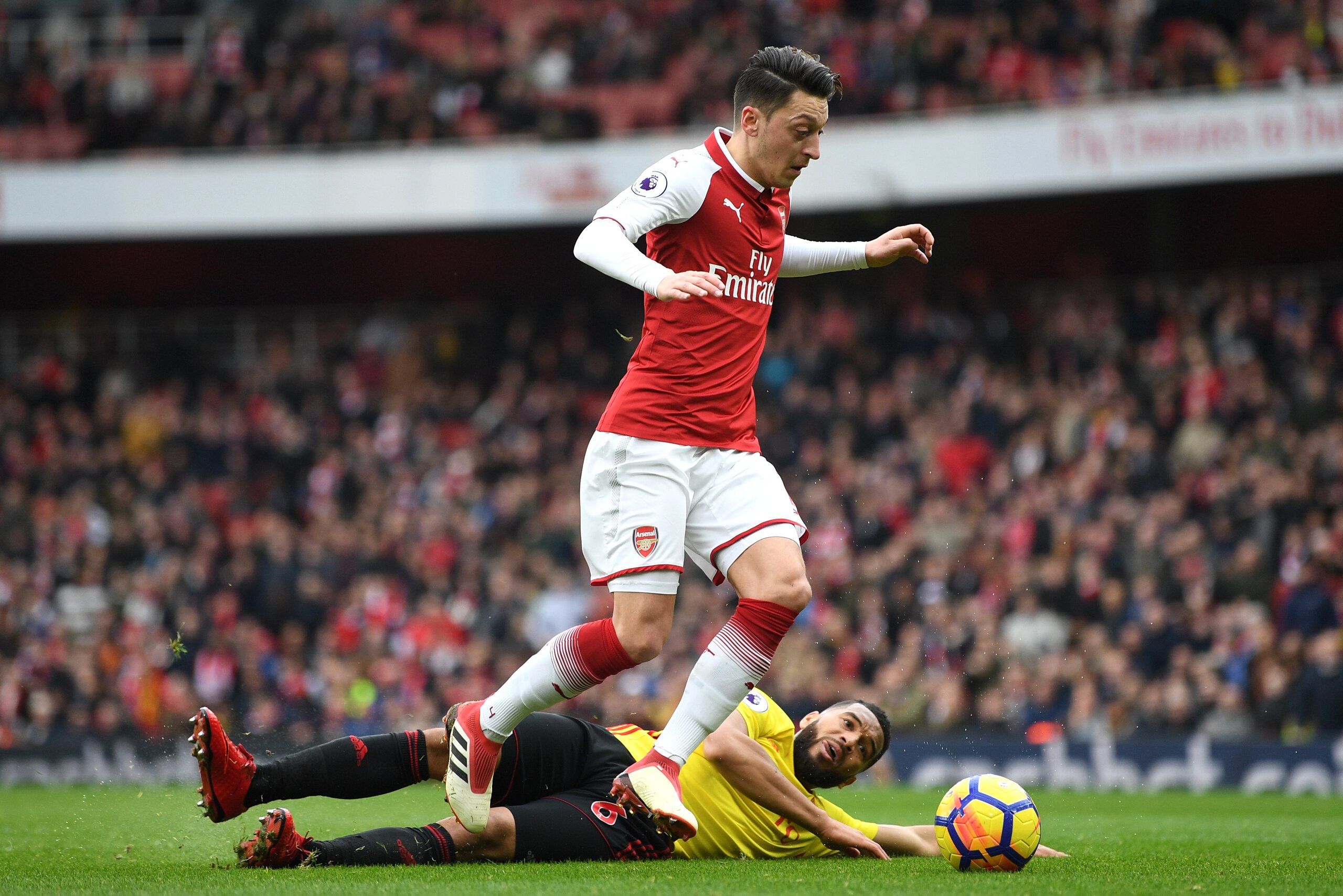 LONDON, ENGLAND - MARCH 11:  Mesut Ozil of Arsenal goes past Adrian Mariappa of Watford  during the Premier League match between Arsenal and Watford at Emirates Stadium on March 11, 2018 in London, England.  (Photo by Michael Regan/Getty Images)